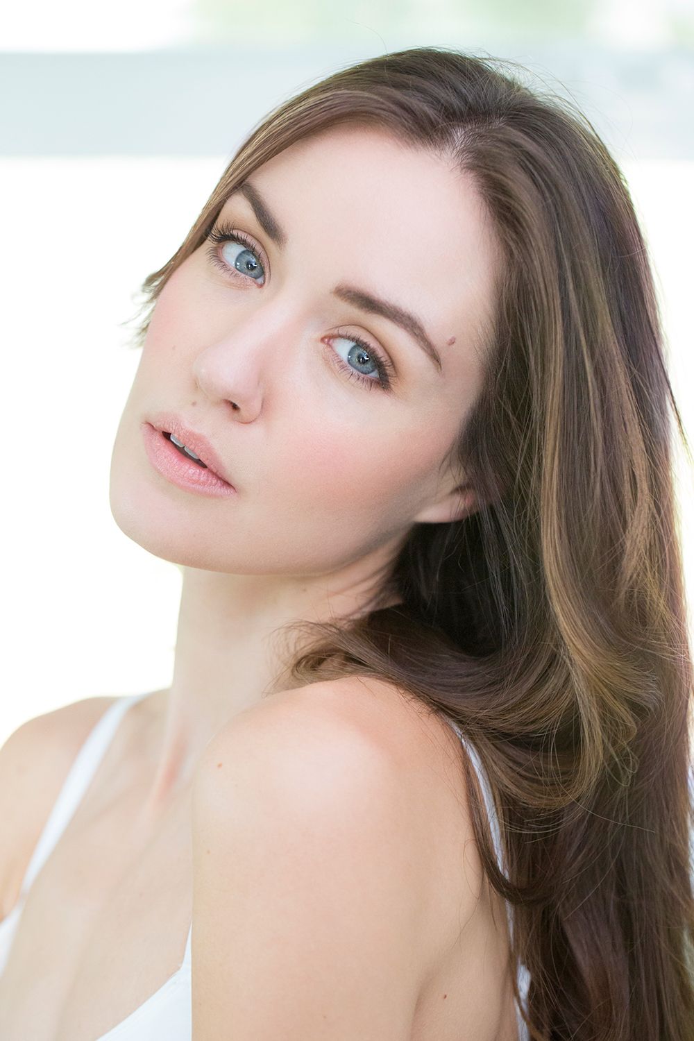 Beauty portrait showcasing glowing skin and soft natural makeup look.