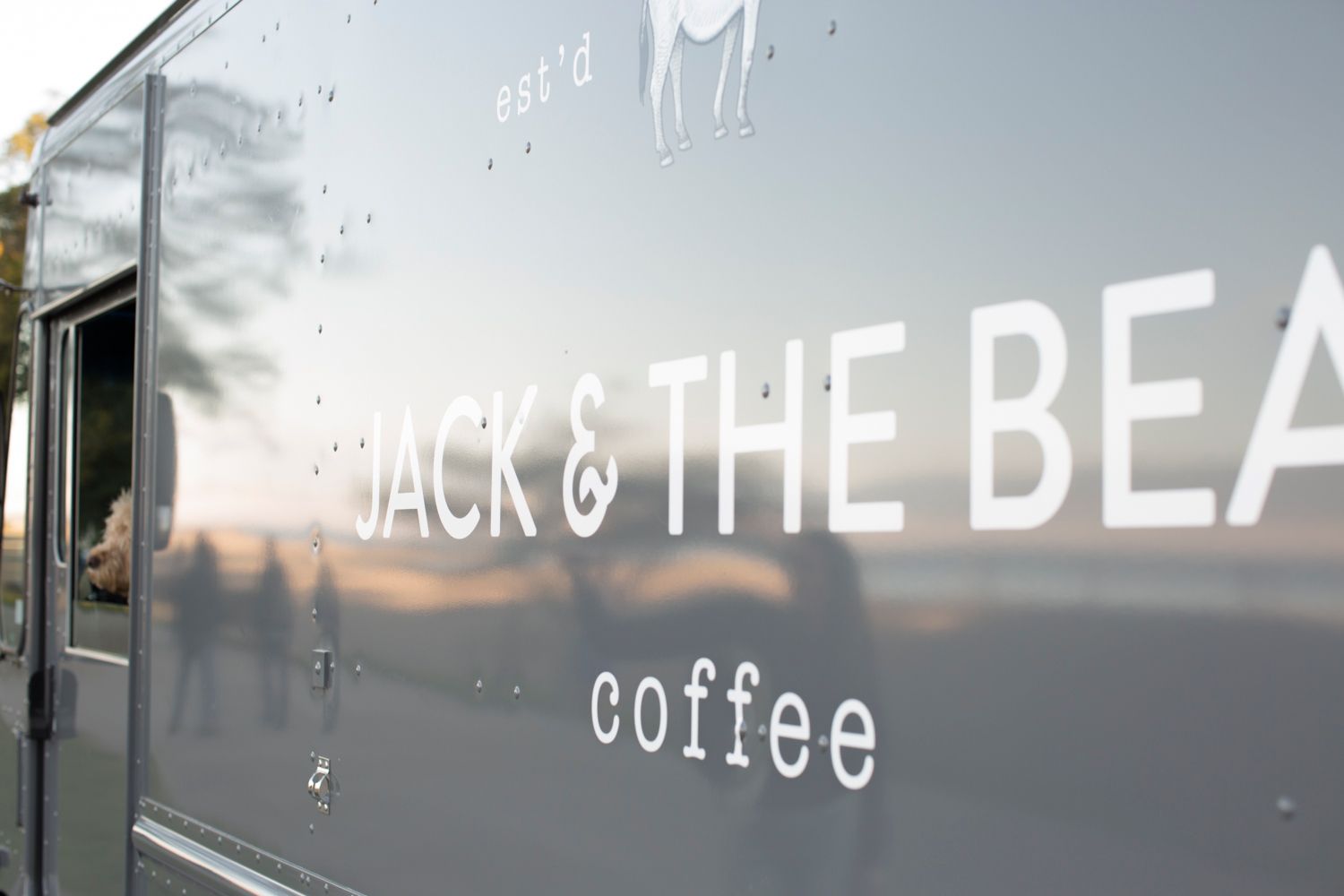Coffee shop storefront signage reading 'Jack & The Bean coffee' on a grey metal surface.