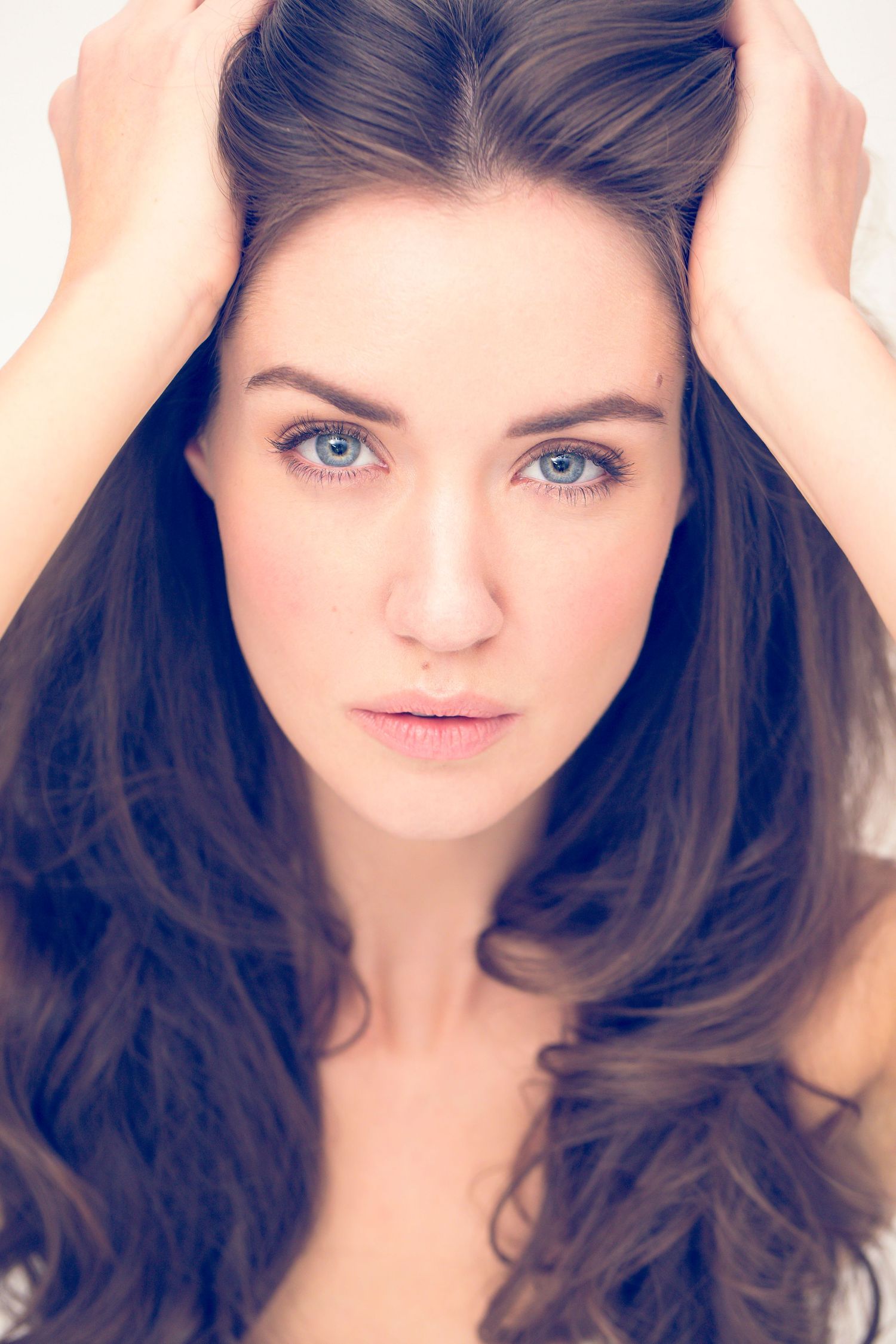 Close-up portrait series showing natural beauty and expressive eyes in studio lighting.