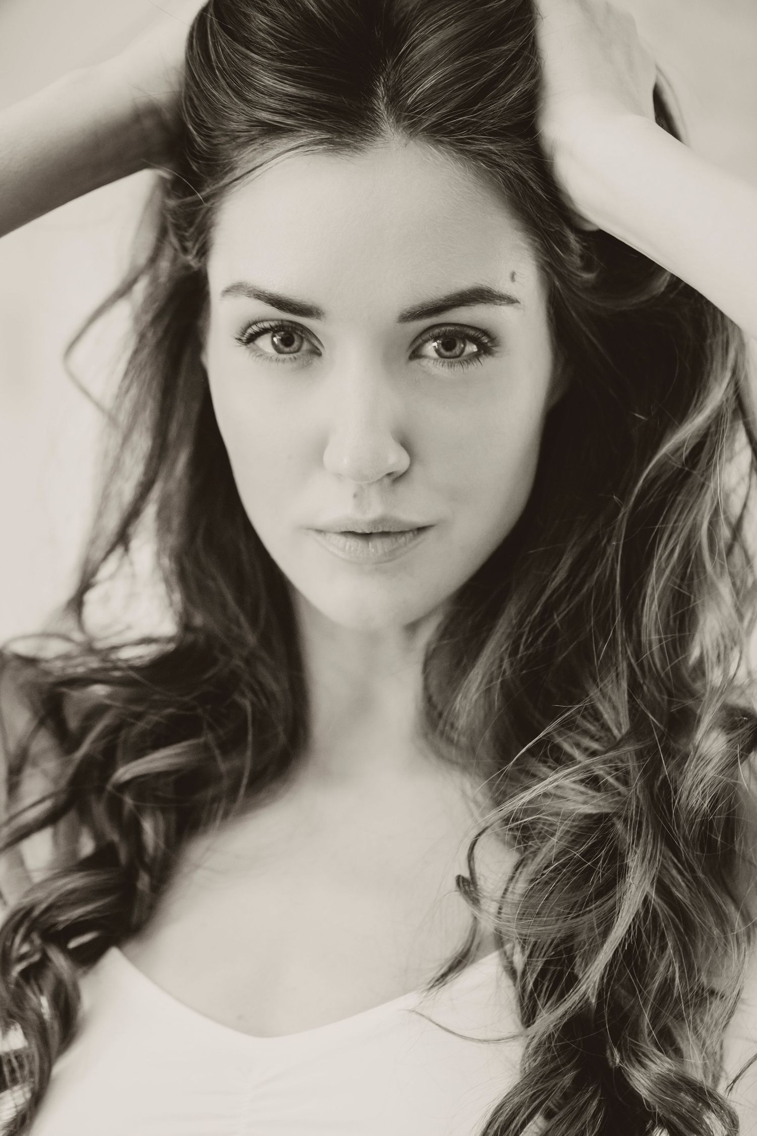 Black and white beauty portrait with long wavy hair.