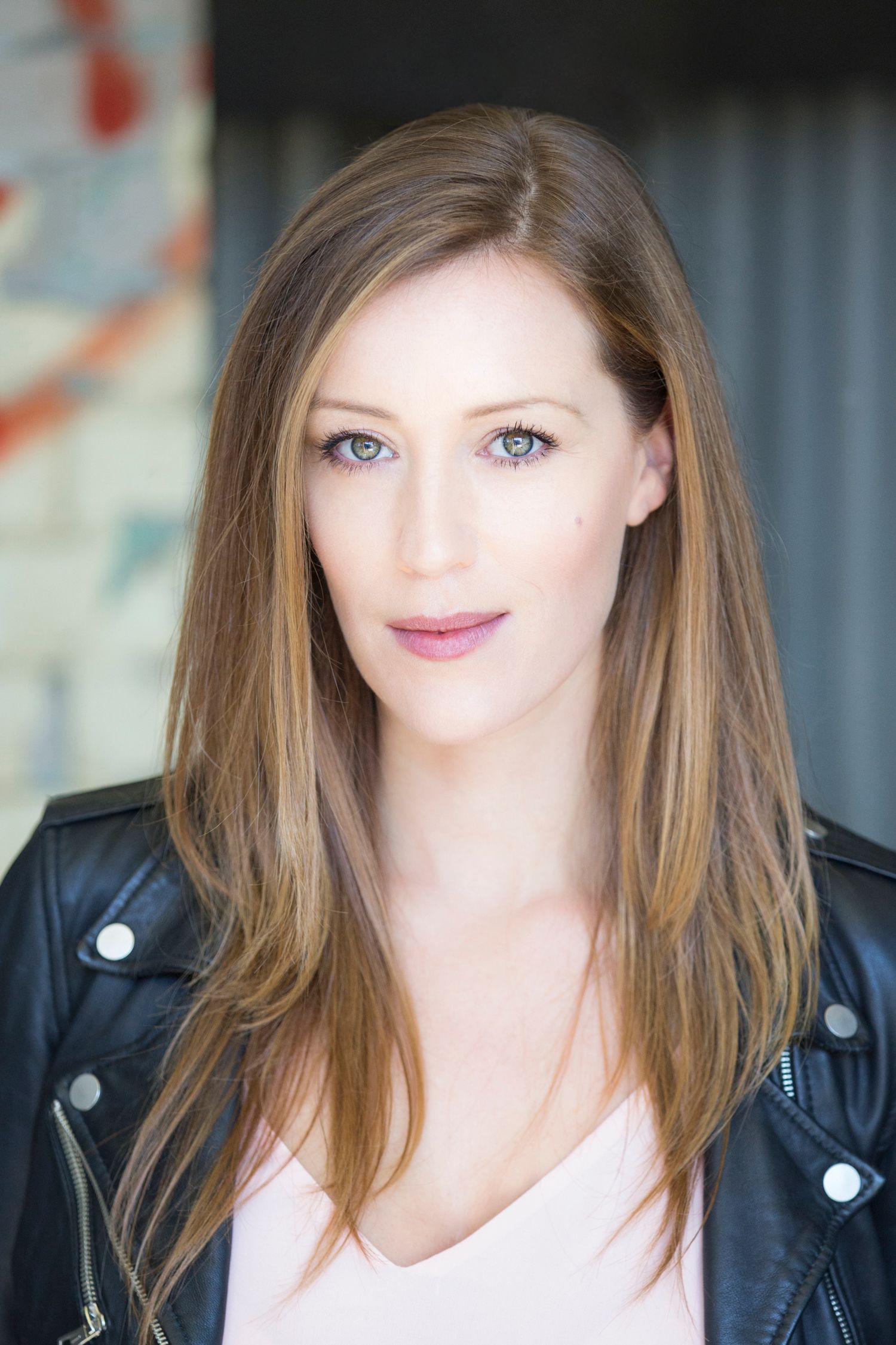 Professional headshot series against gray background wearing leather jacket.
