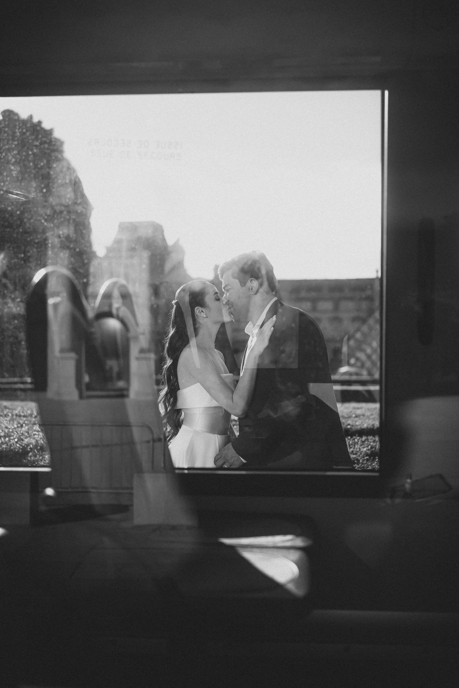 A series of black and white film frames showing silhouettes of a couple through a window in a romantic moment.