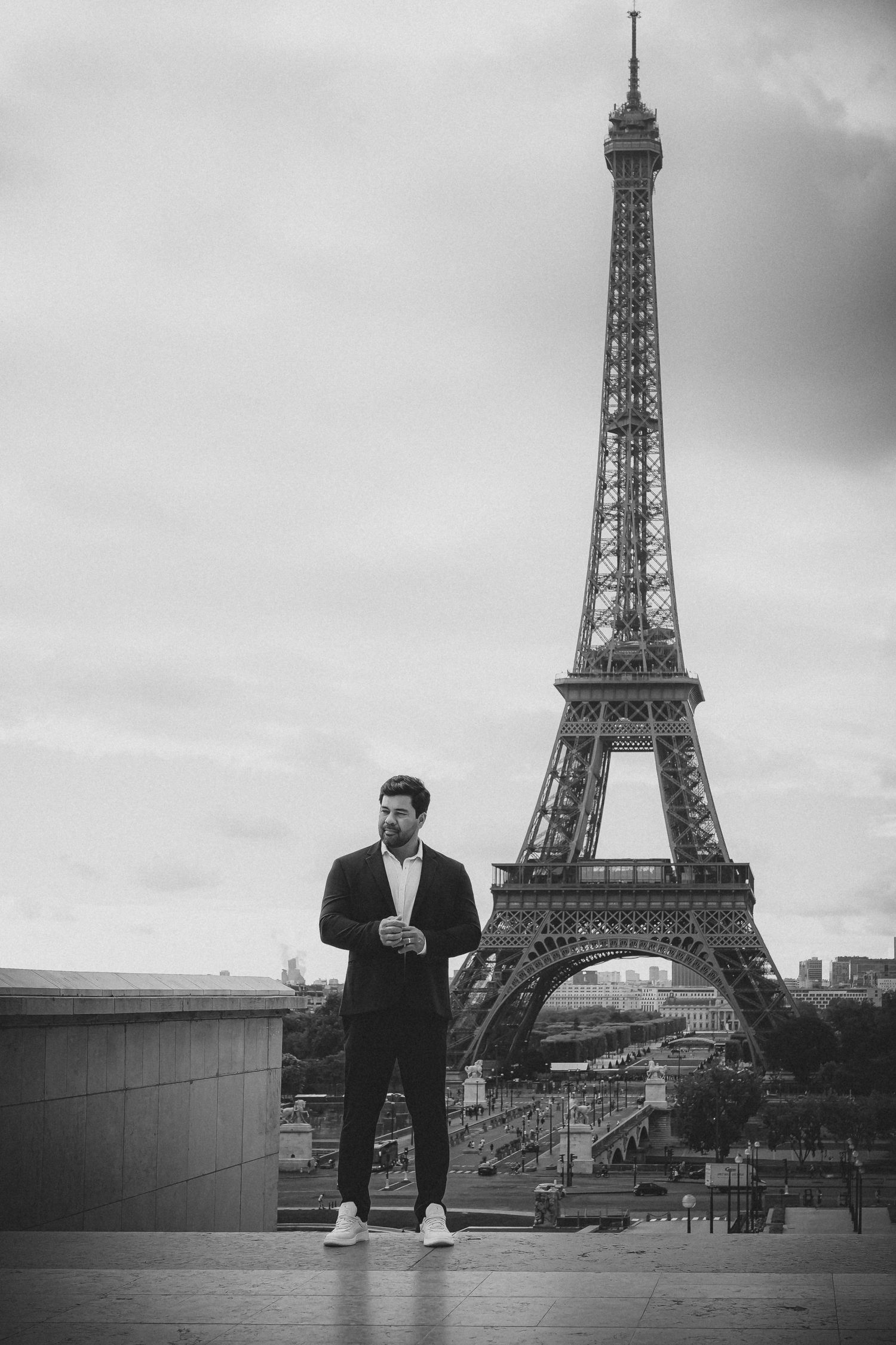 A black and white photo sequence showing someone posing at different distances from the Eiffel Tower in Paris.