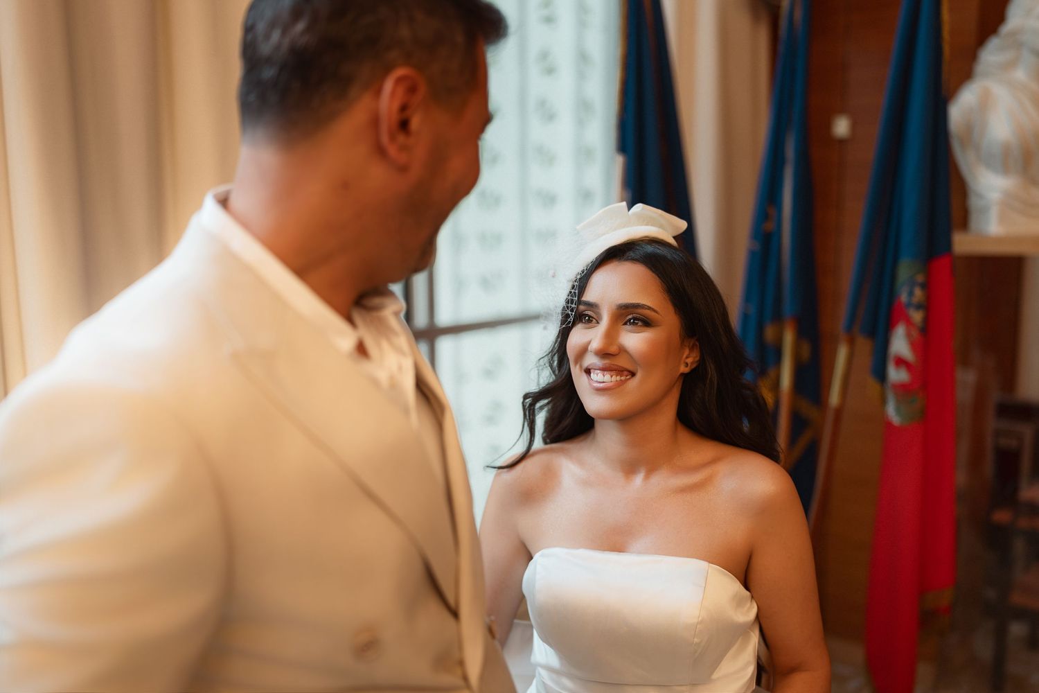 A bride and groom share a tender moment during their first dance at an elegant wedding reception.
