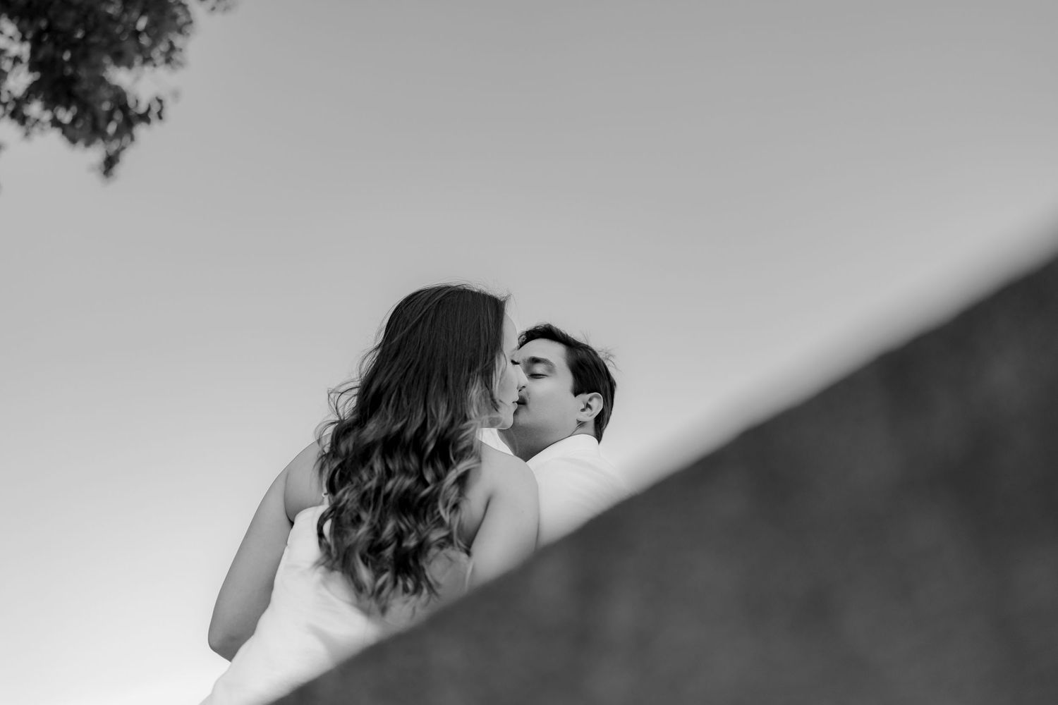 A black and white photo series showing a couple embracing and dancing together in an intimate moment.