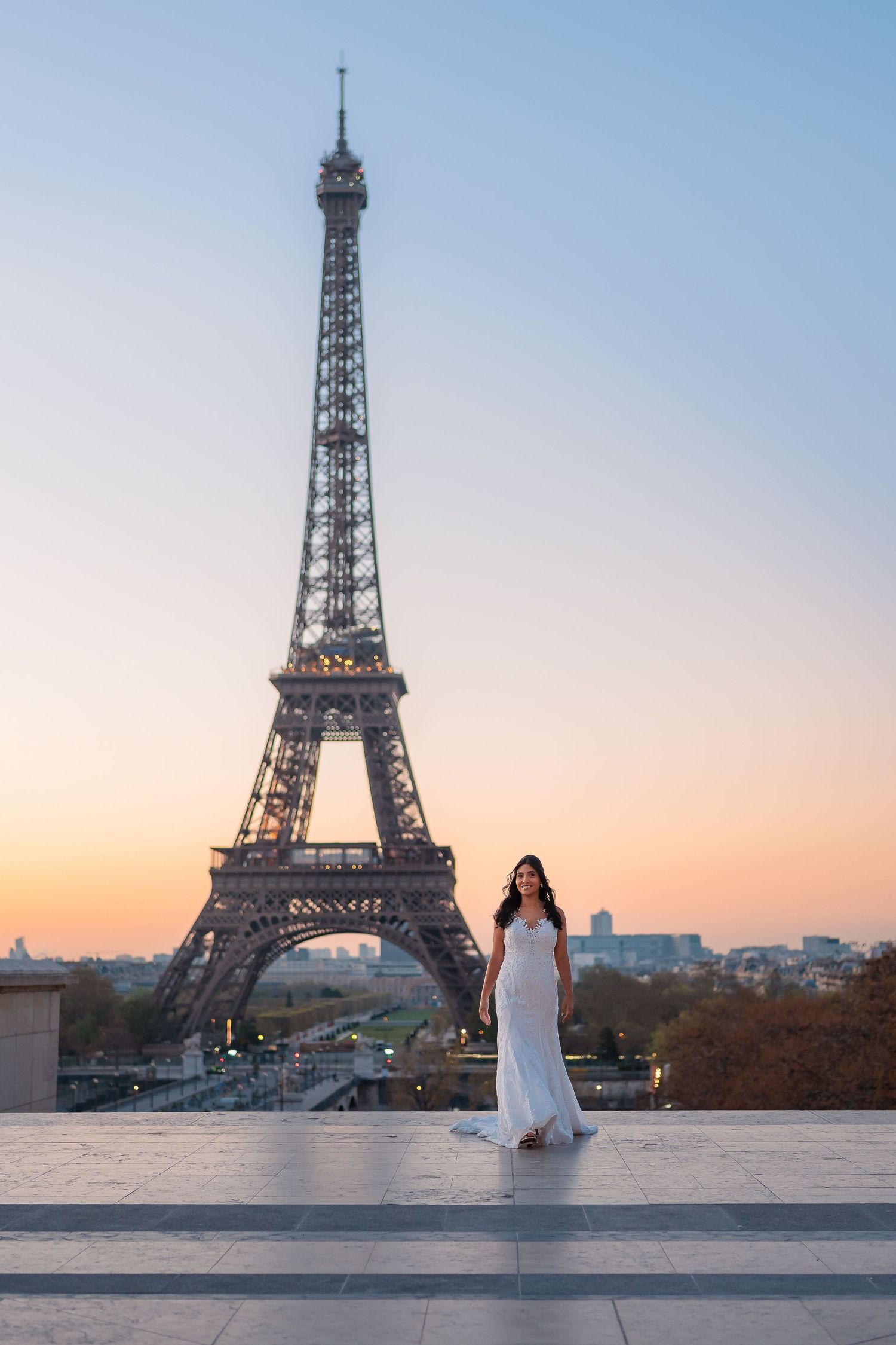 A series of photos showing a person in a white dress posing at different angles in front of the Eiffel Tower at sunset.