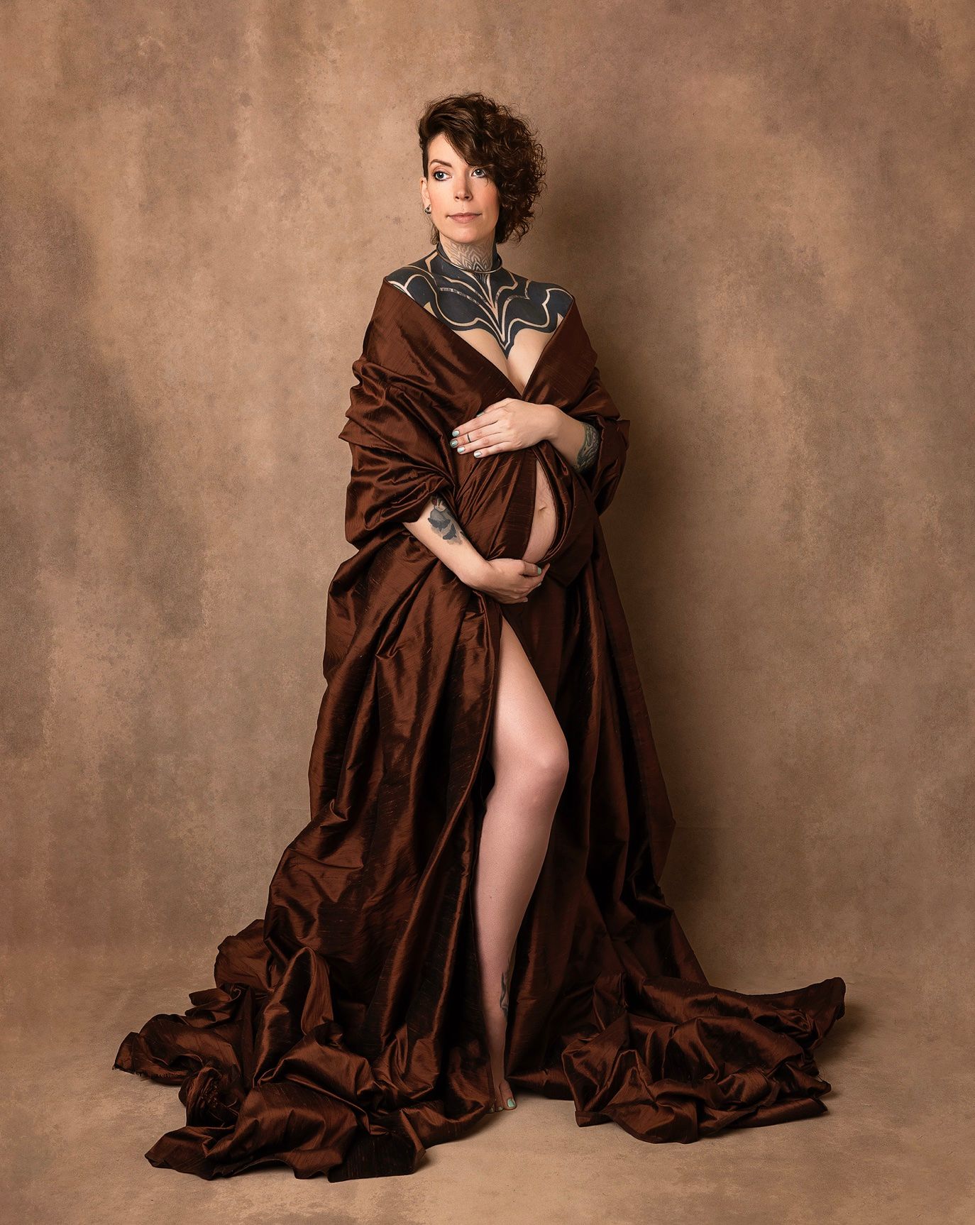 Artistic portrait series featuring flowing brown fabric draping against textured sepia background.