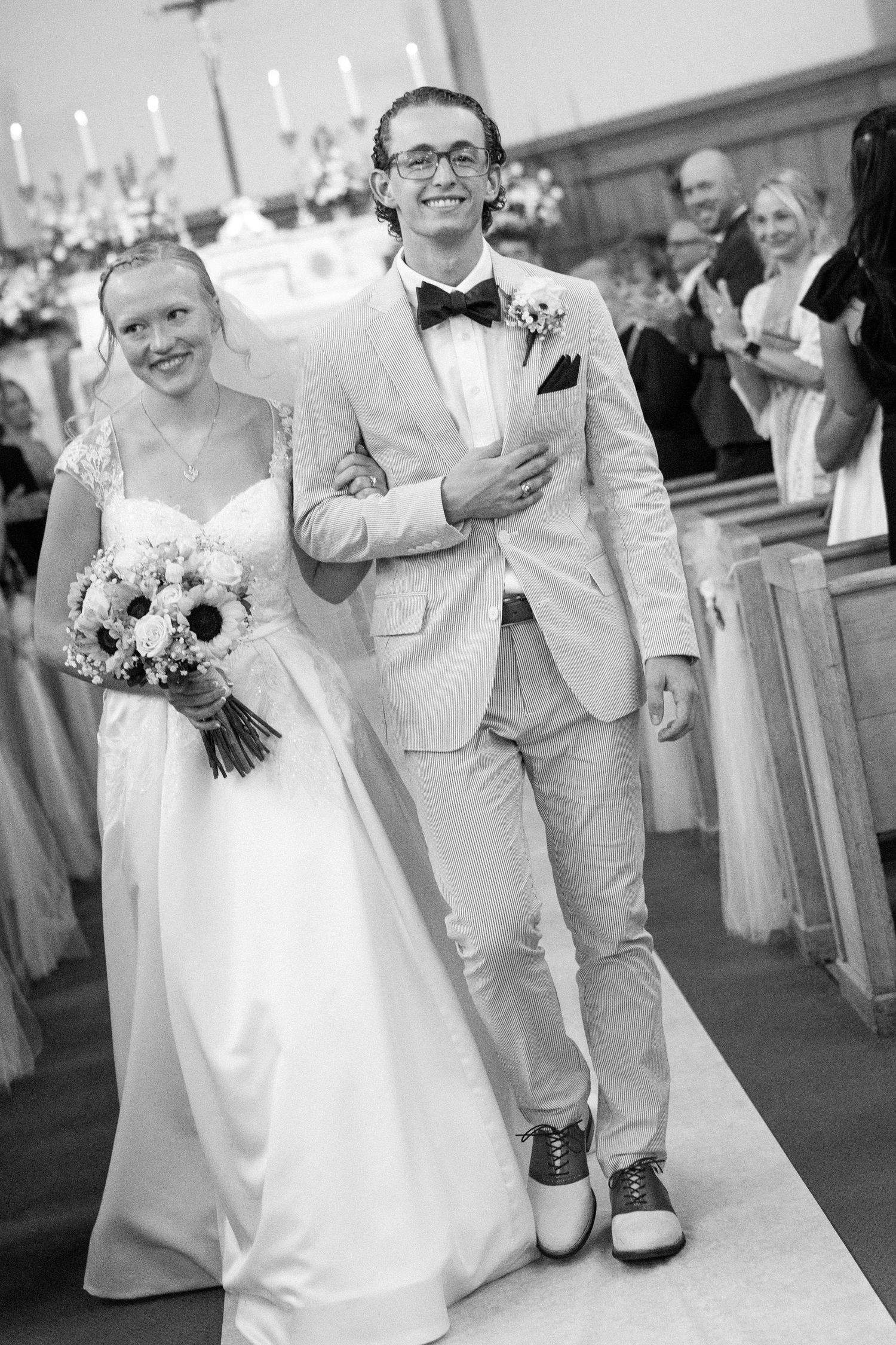 Black and white photo series showing happy moments at a wedding celebration with couple and guests in formal attire.