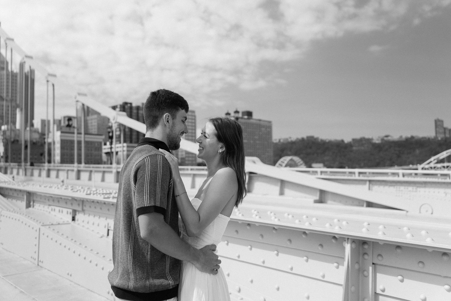 A black and white photo of a couple on the Roberto Clemente Bridge in Pittsburgh. PA