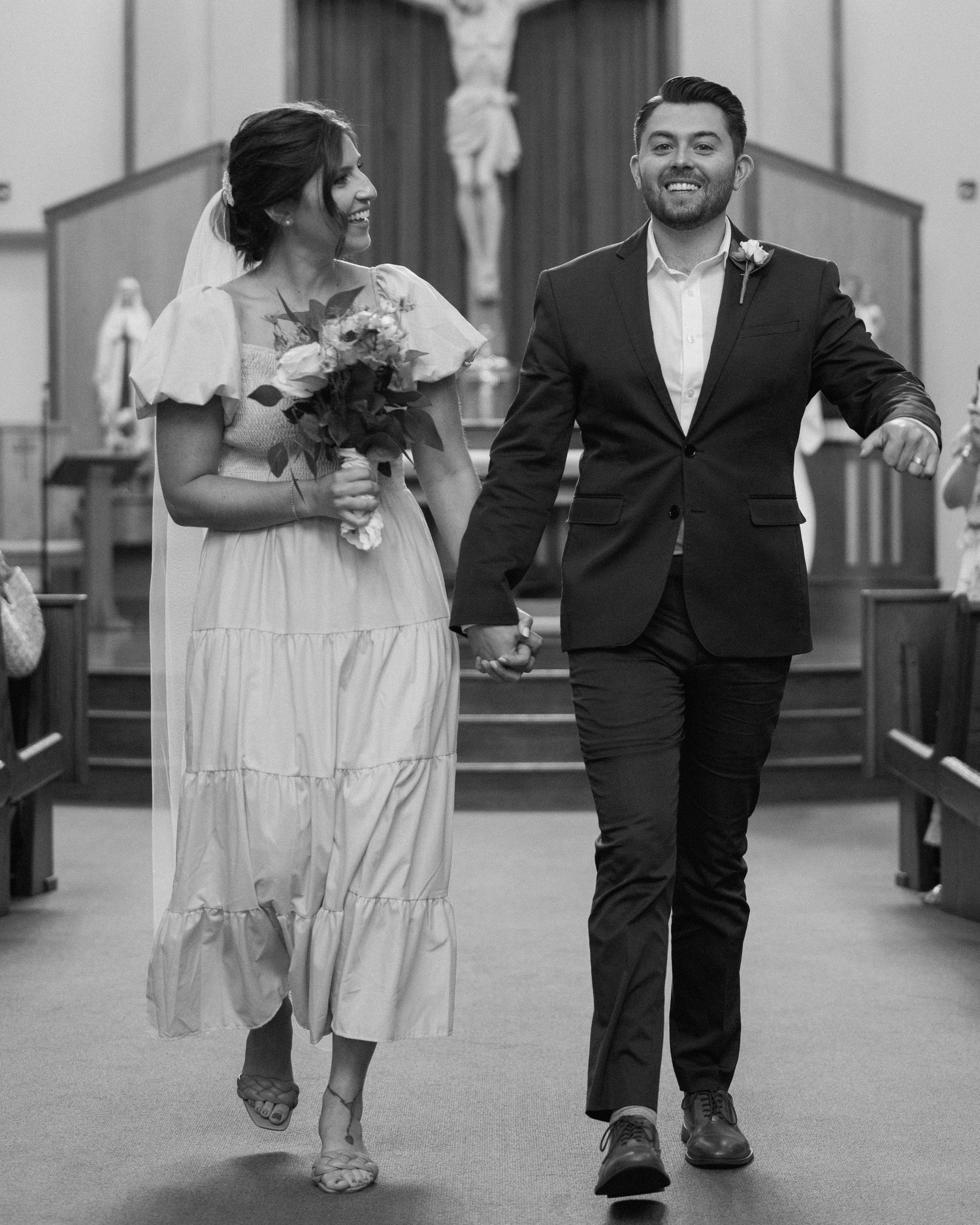 A happy couple walking down the church aisle after their wedding ceremony.