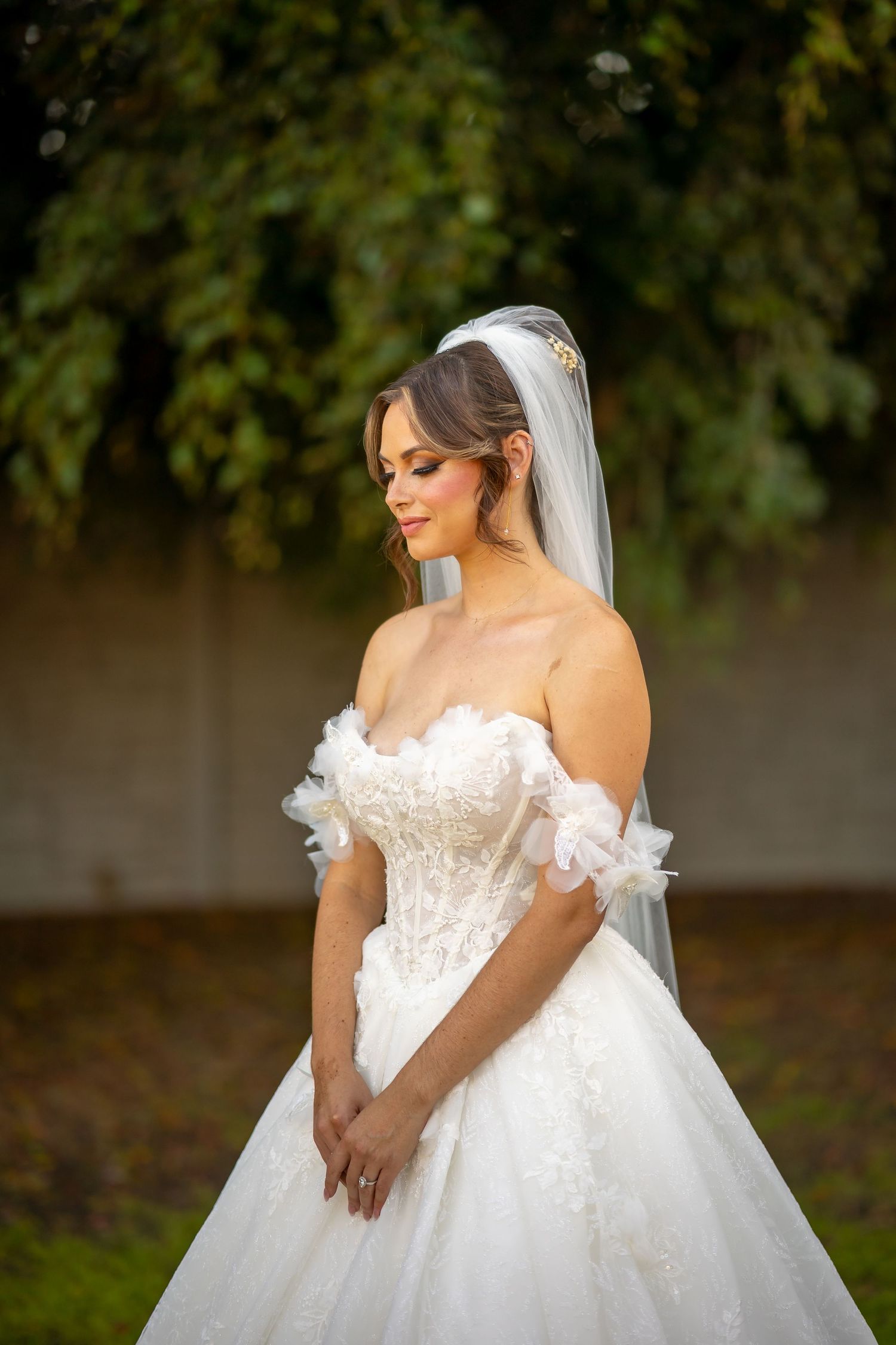 Beautiful white wedding gown with delicate lace details and off-shoulder design.