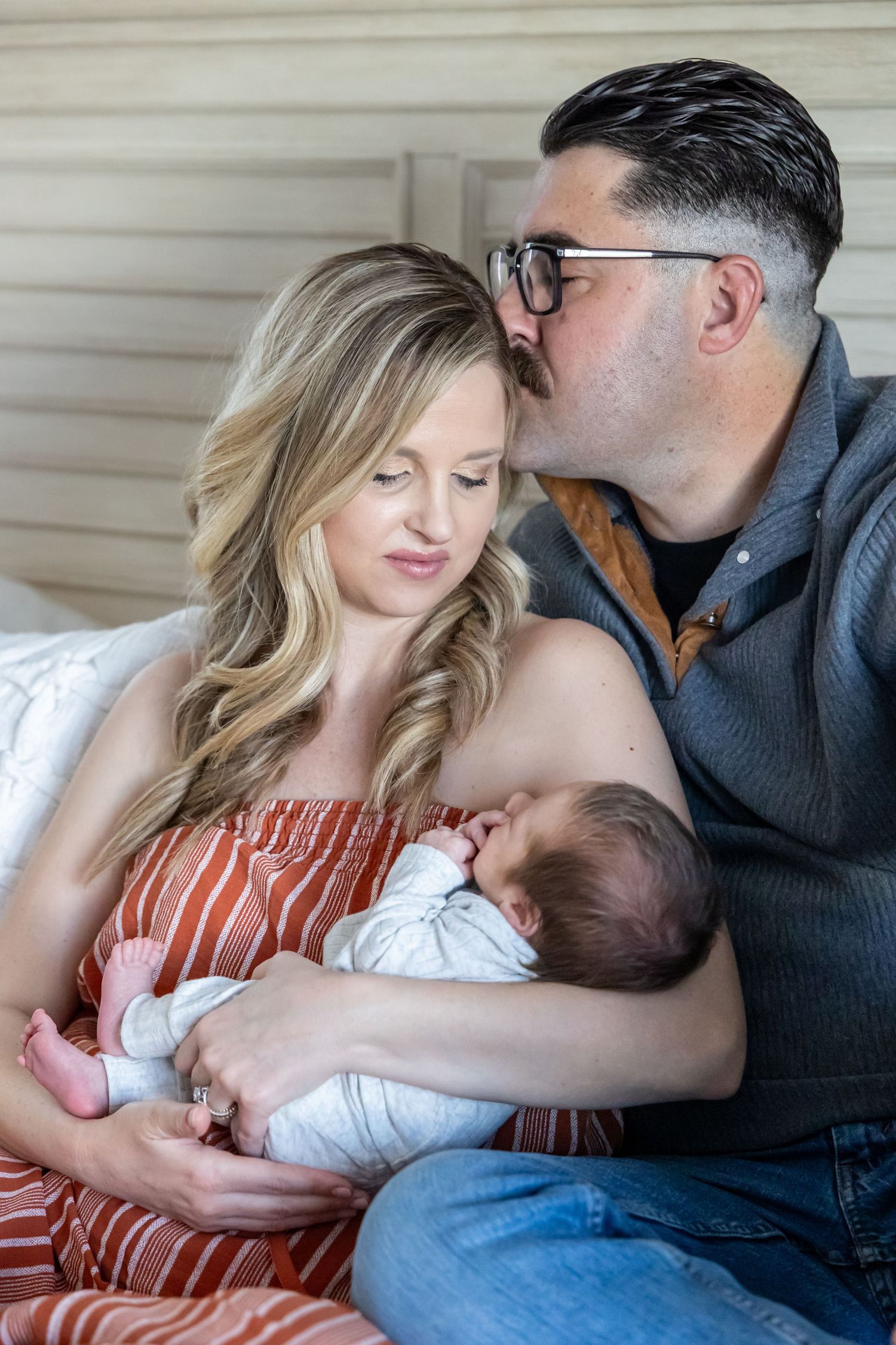 Tender family moments captured in a casual home setting with natural window light.