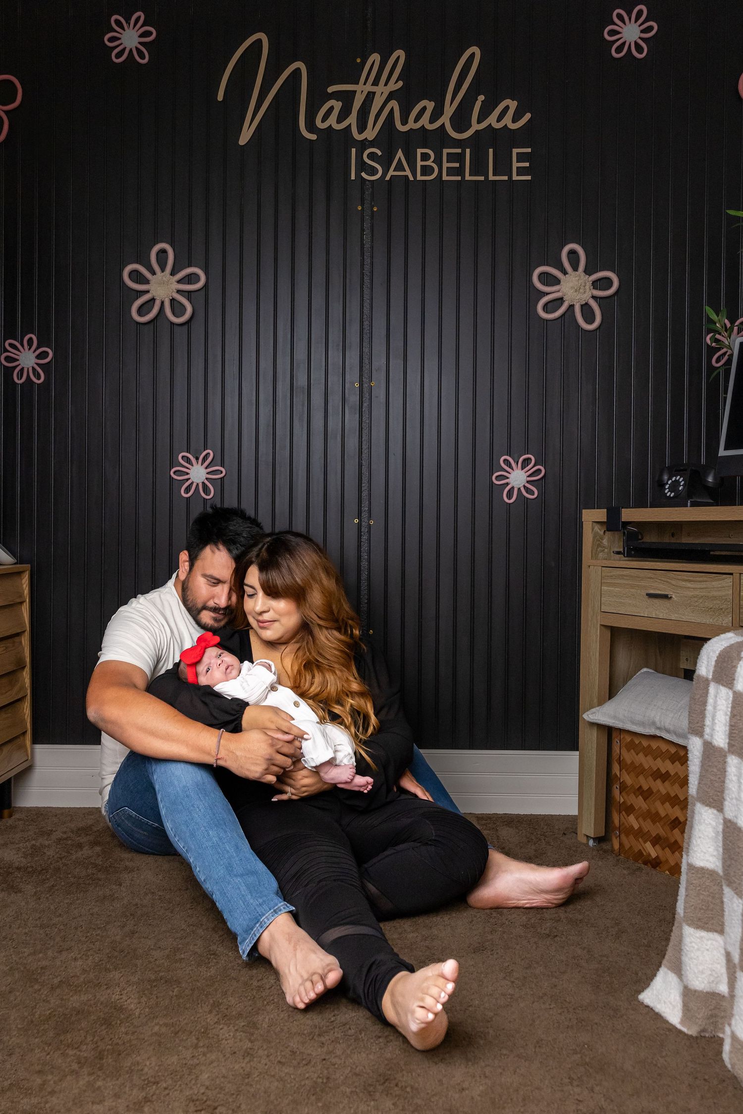 Family lifestyle photos against a dark wall with decorative text and floral elements.