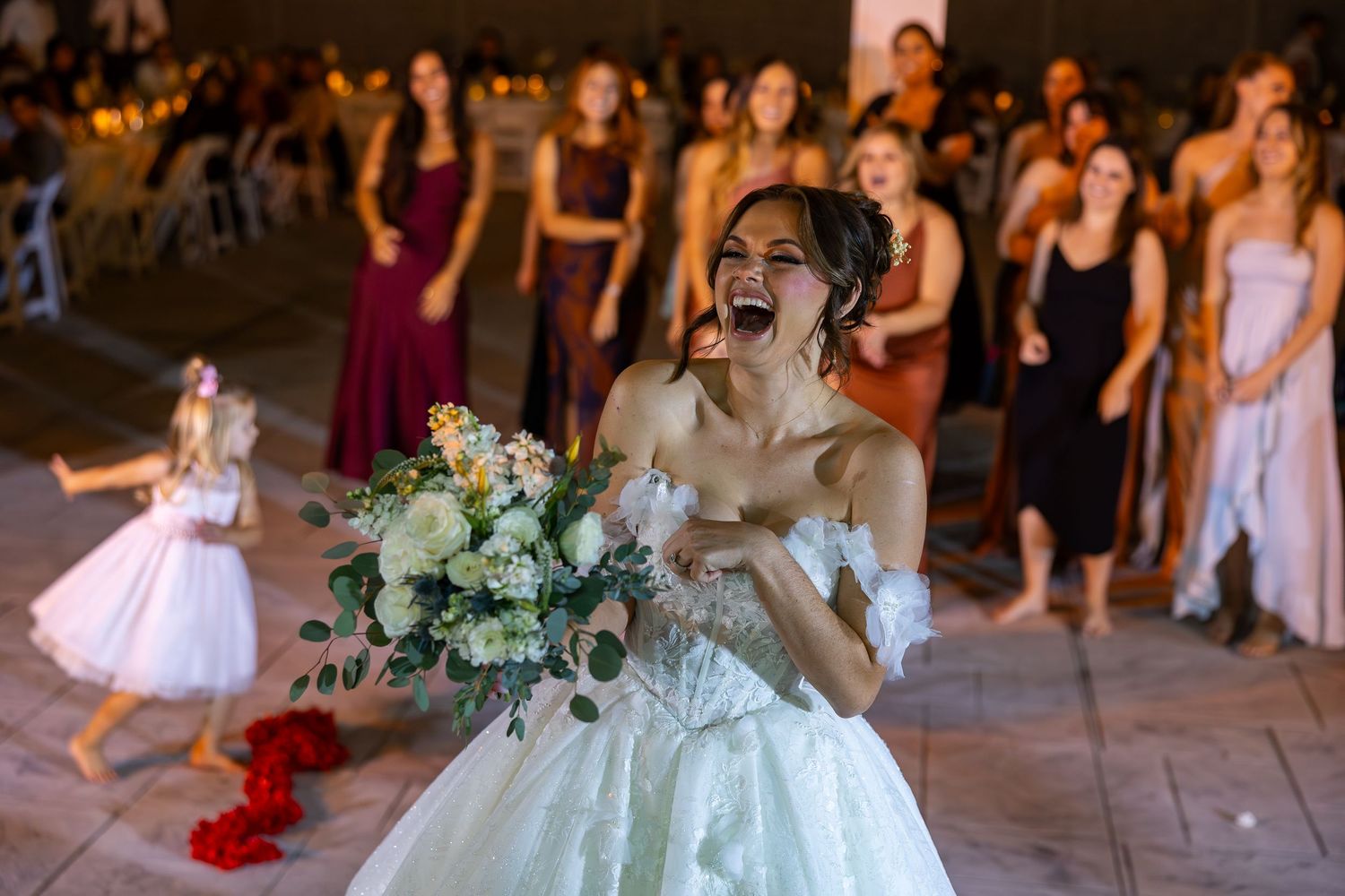 Elegant wedding reception setup with floral centerpieces and string lighting.