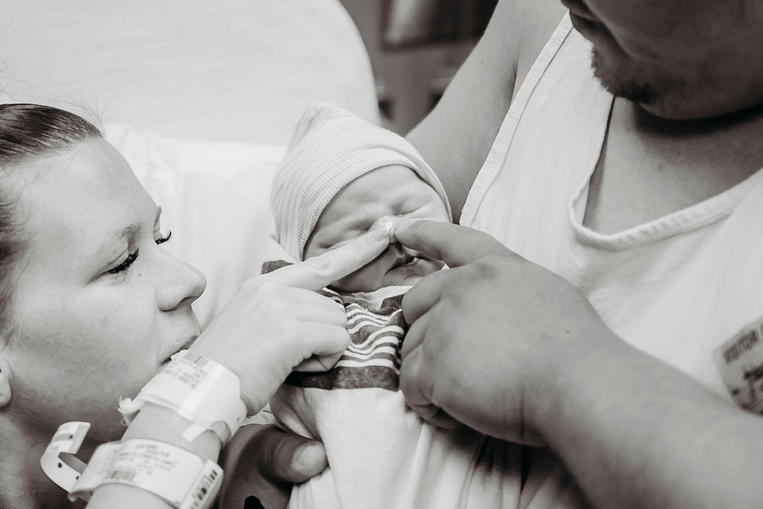 Medical professionals providing newborn care in a hospital setting.