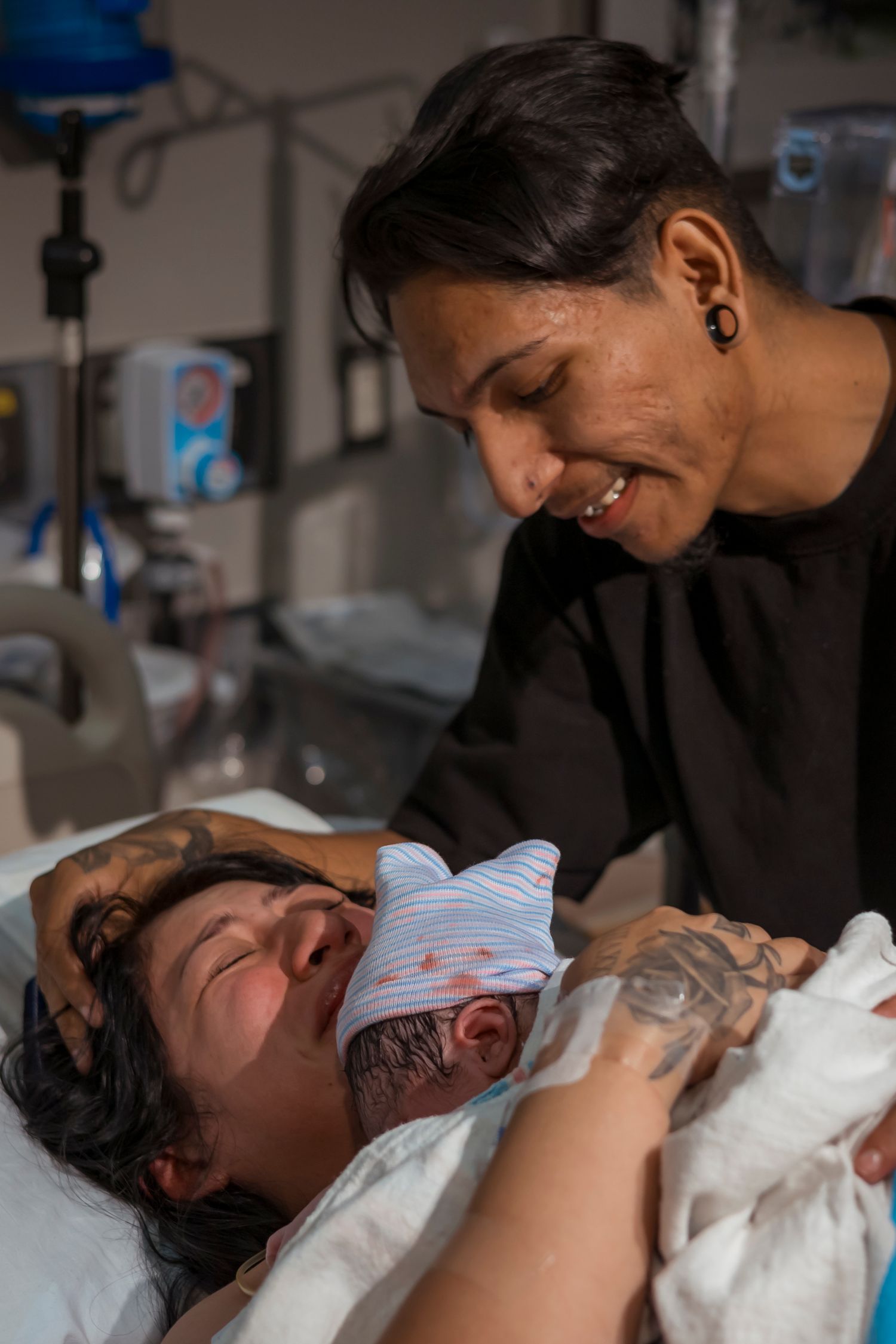 Emotional birthing scene in hospital with medical support team.