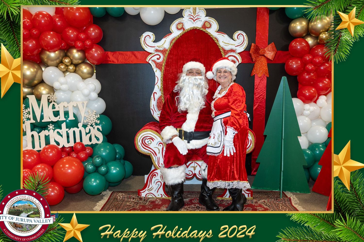 Holiday balloon arch display with red, green and white decorations featuring Santa Claus and festive Christmas designs.