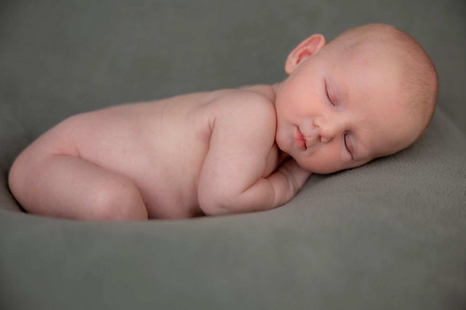 Artistic black and white portraits of sleeping newborn baby.