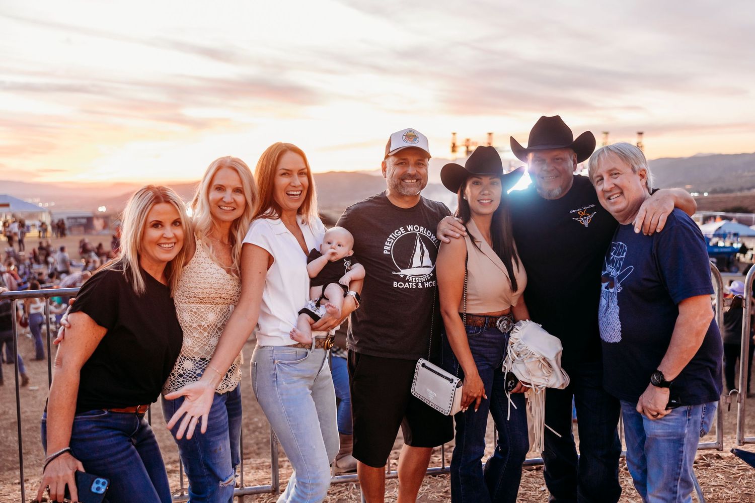 Happy festival attendees gathered for group photos at sunset during a country music event.