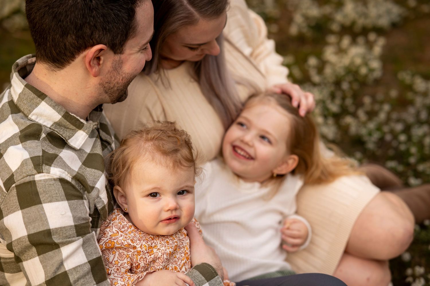 Candid family moment captured outdoors with warm autumn tones and natural lighting.