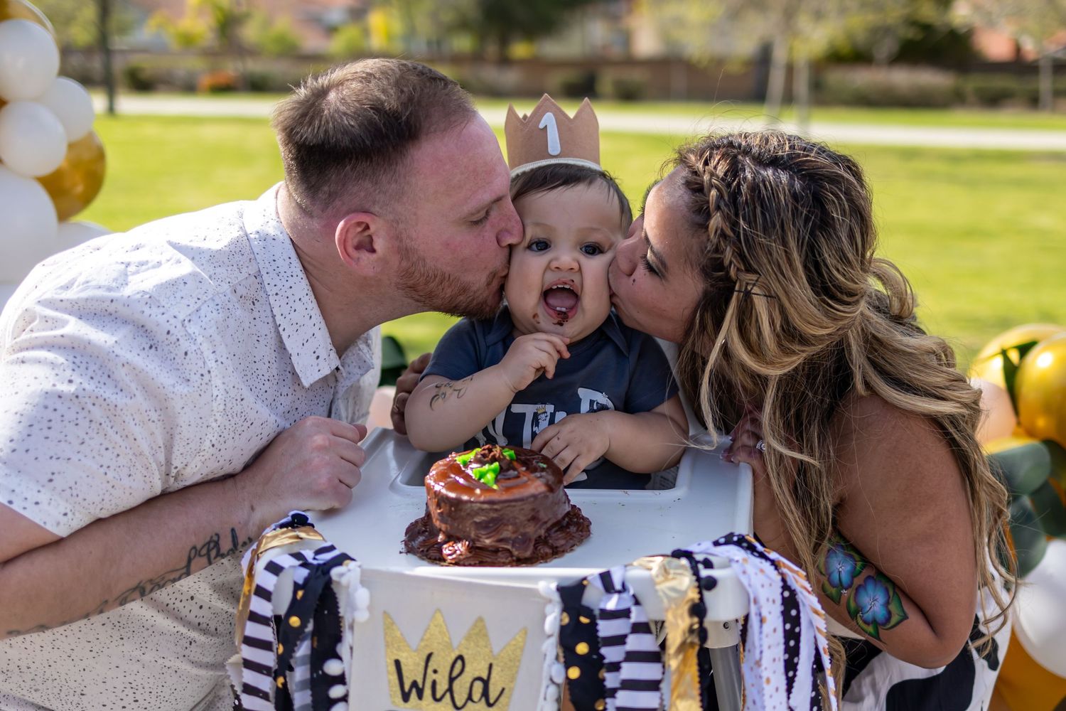 Sweet family moment during first birthday celebration with cake.