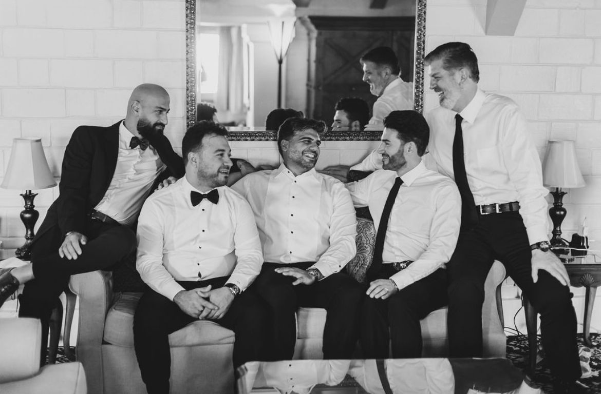 A black and white wedding photo of the groom and groomsmen in Riverside
