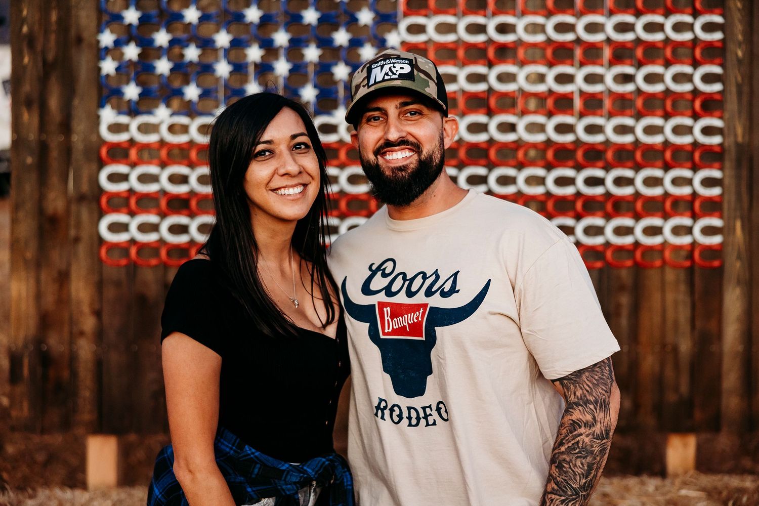 Festival attendees pose in front of a decorative American flag display.