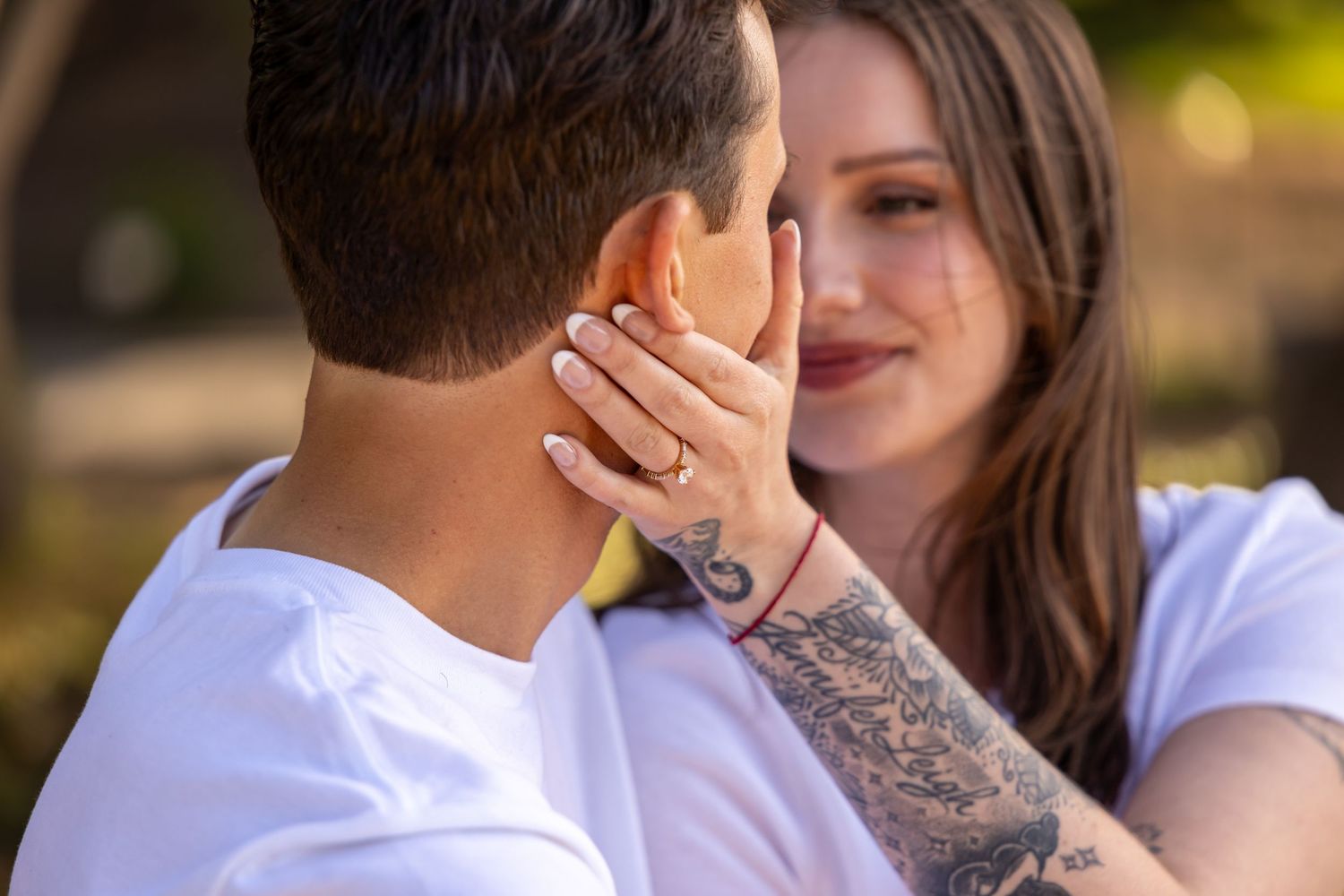Intimate moment captured between couple during outdoor photoshoot.