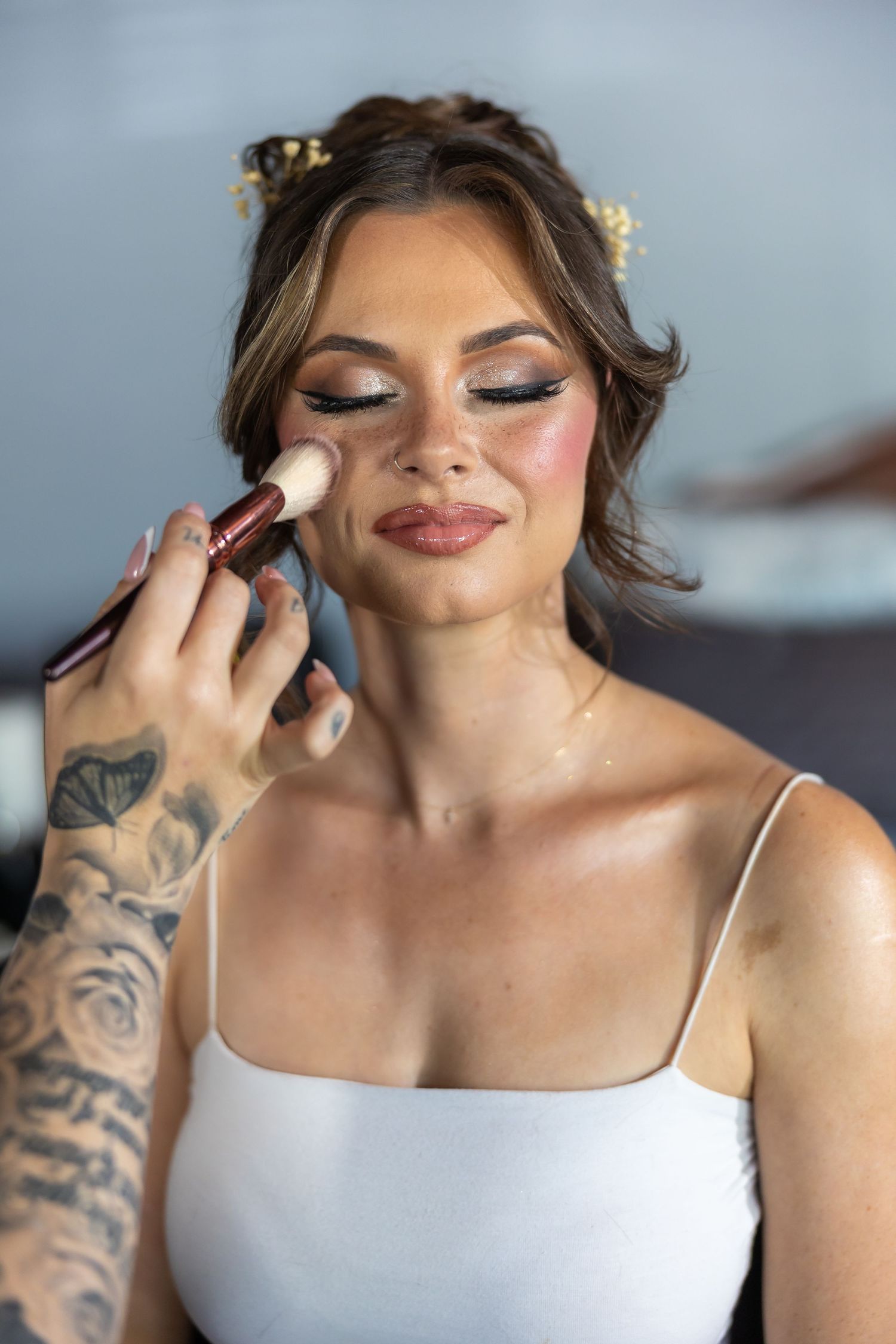 A glamorous bridal makeup application showing shimmery eyeshadow and perfect complexion.