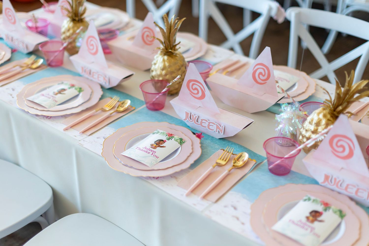 Elegant table settings with gold utensils and pink accents at a special event in Huntington Beach.