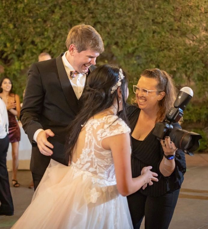 Hilary shares a laugh with a wedding couple in San Juan Capistrano