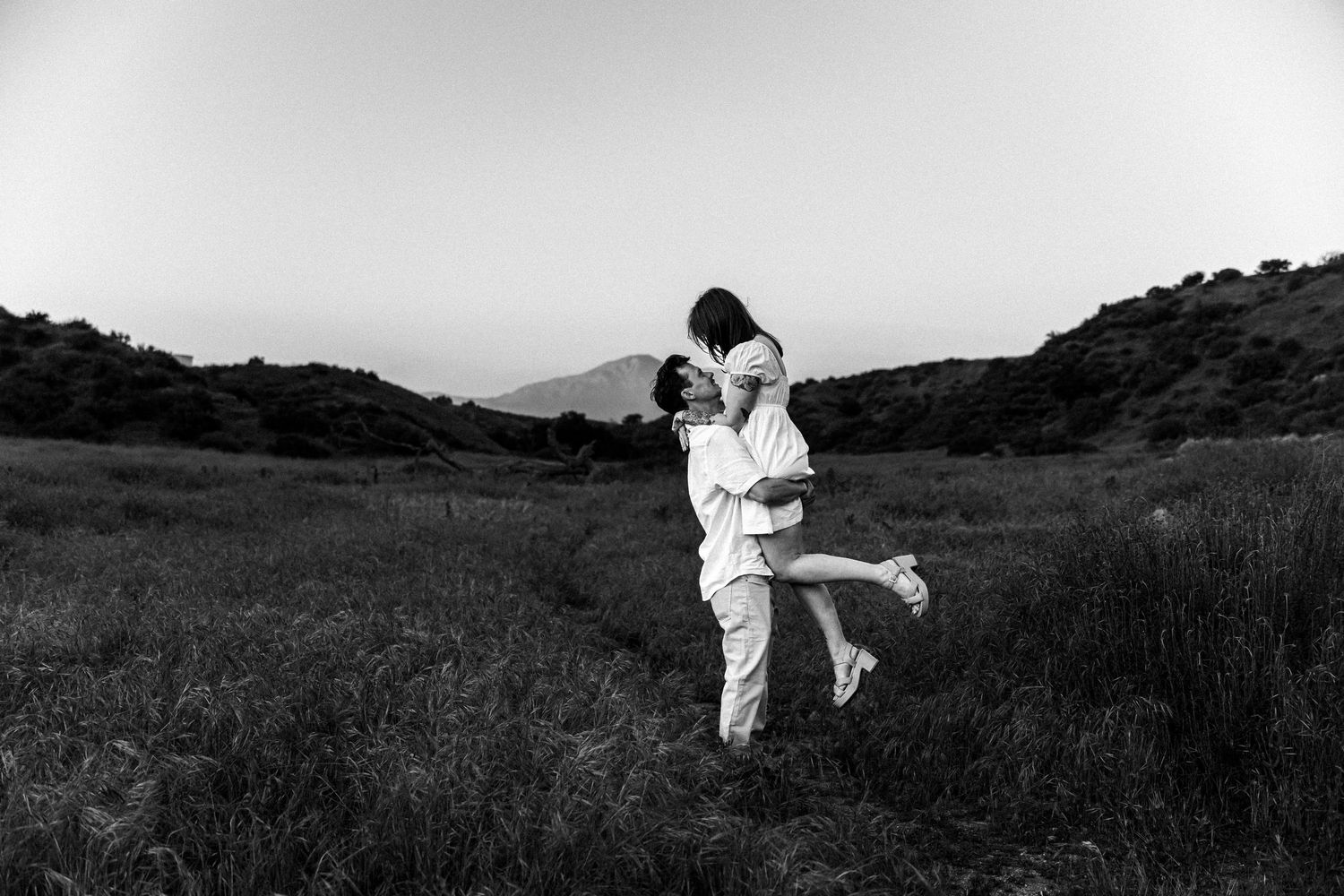 A black and white artistic engagement photo series in a natural outdoor setting.