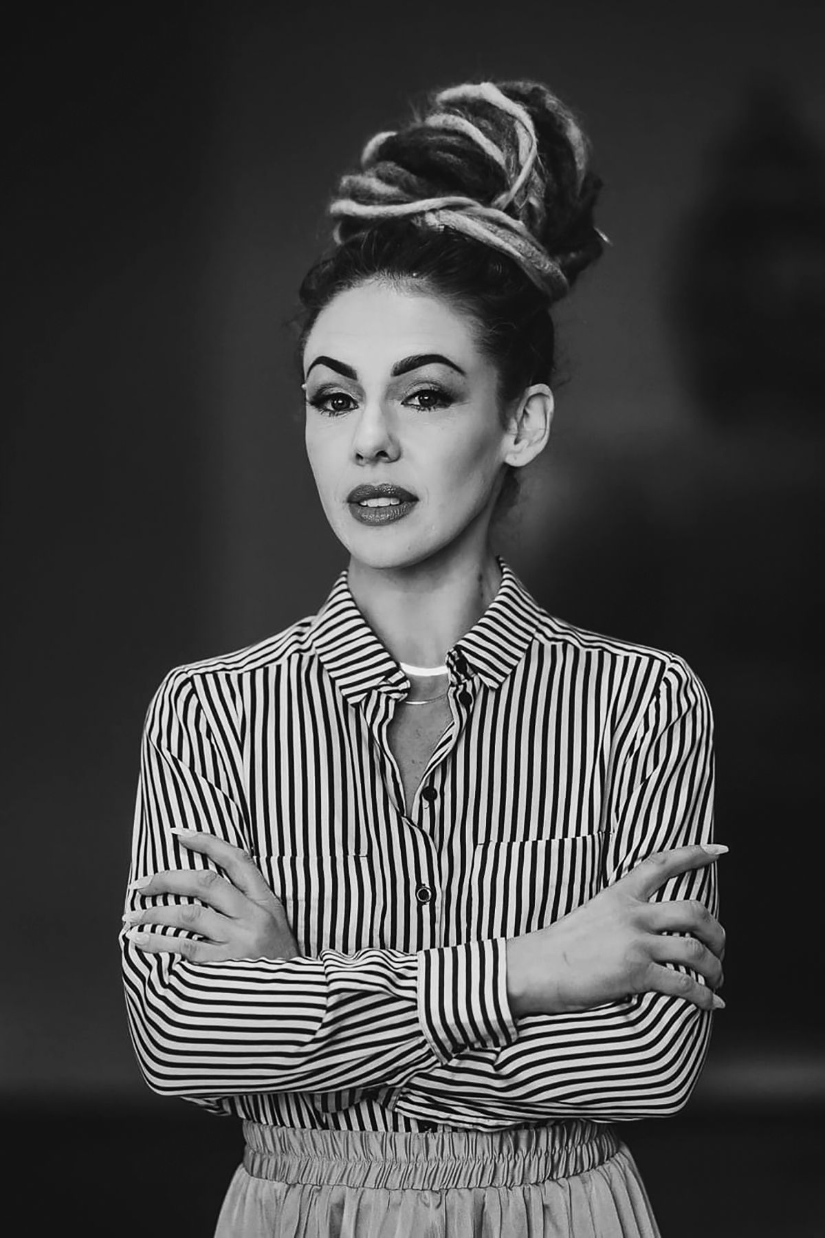 Artistic black and white portrait series showing a person in striped clothing striking dramatic poses.