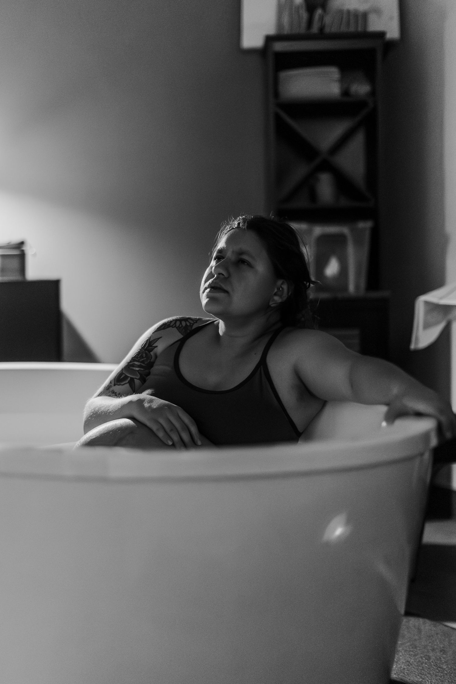 Black and white images of peaceful moments in a bathtub during labor.
