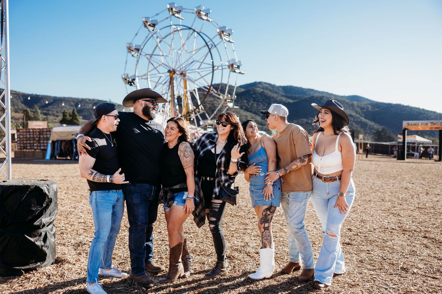 Festival attendees enjoying an outdoor country music event in a desert setting.