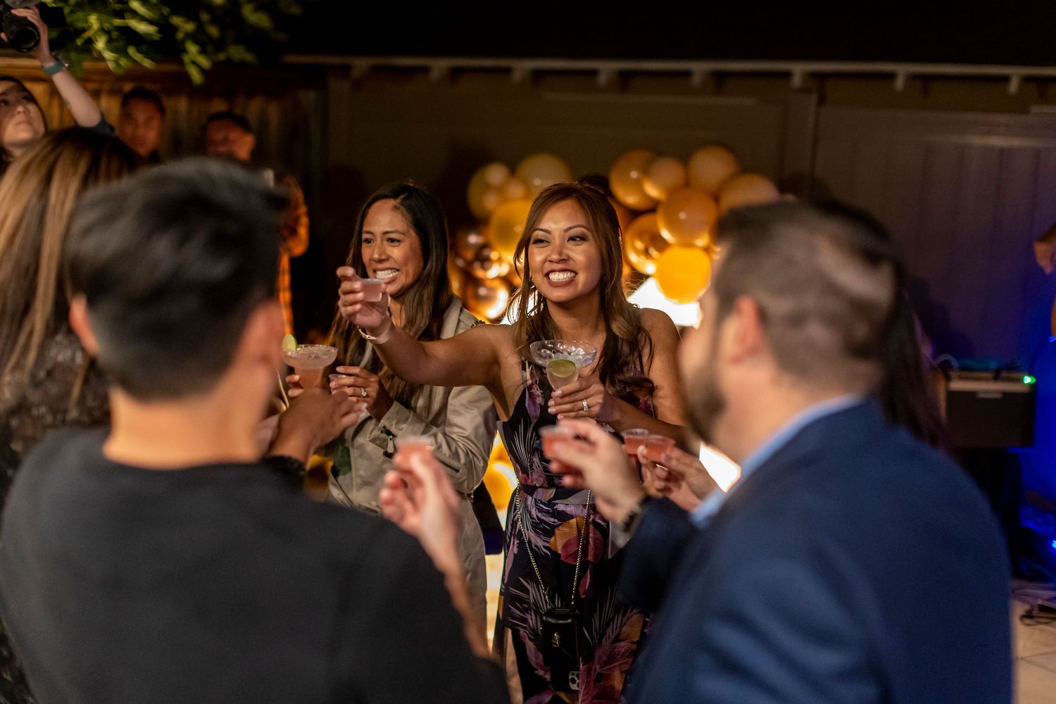 Group enjoying live music entertainment at party with golden balloon decorations in Anaheim.