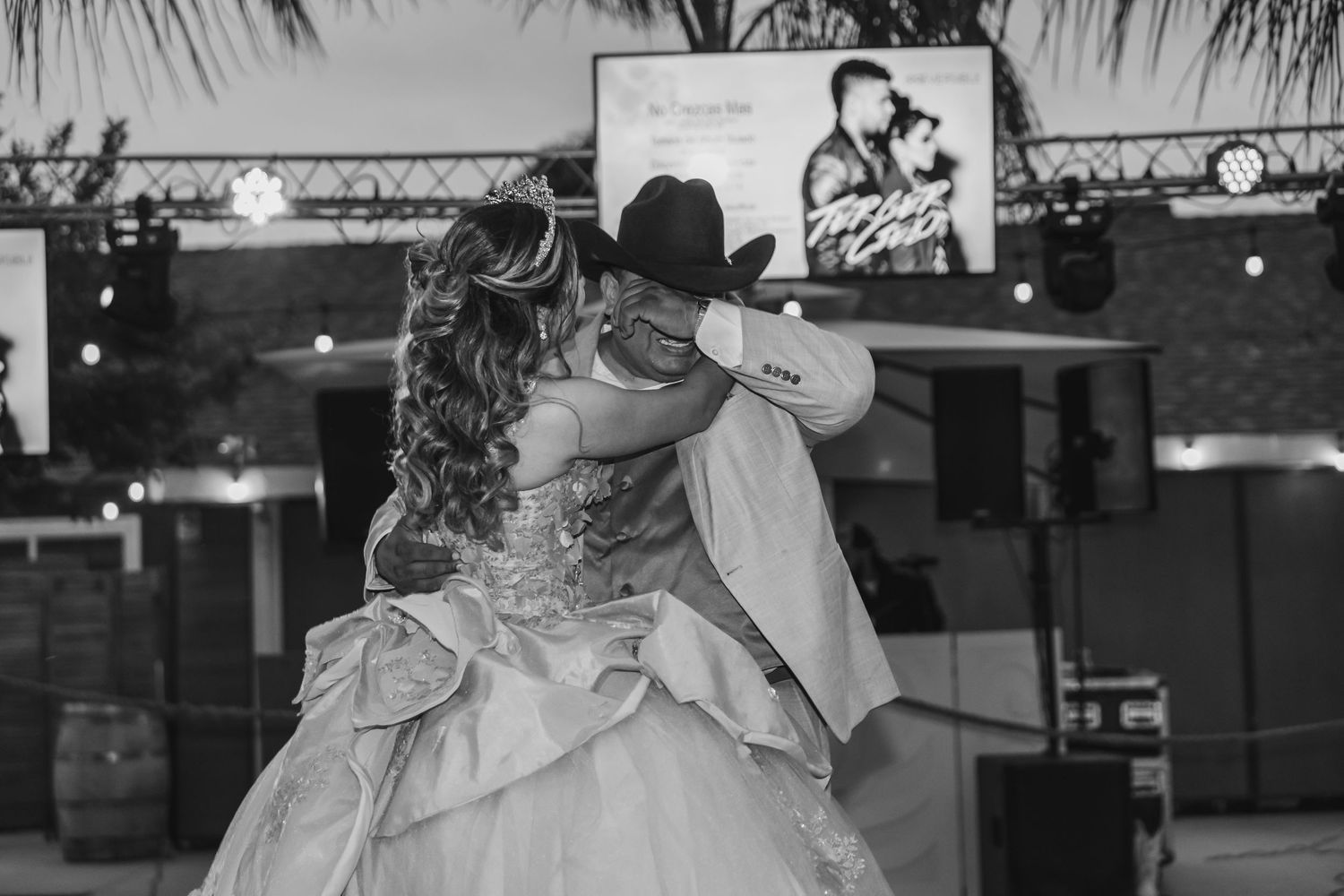 Black and white father-daughter quince dancing under evening lighting in San Jacinto.