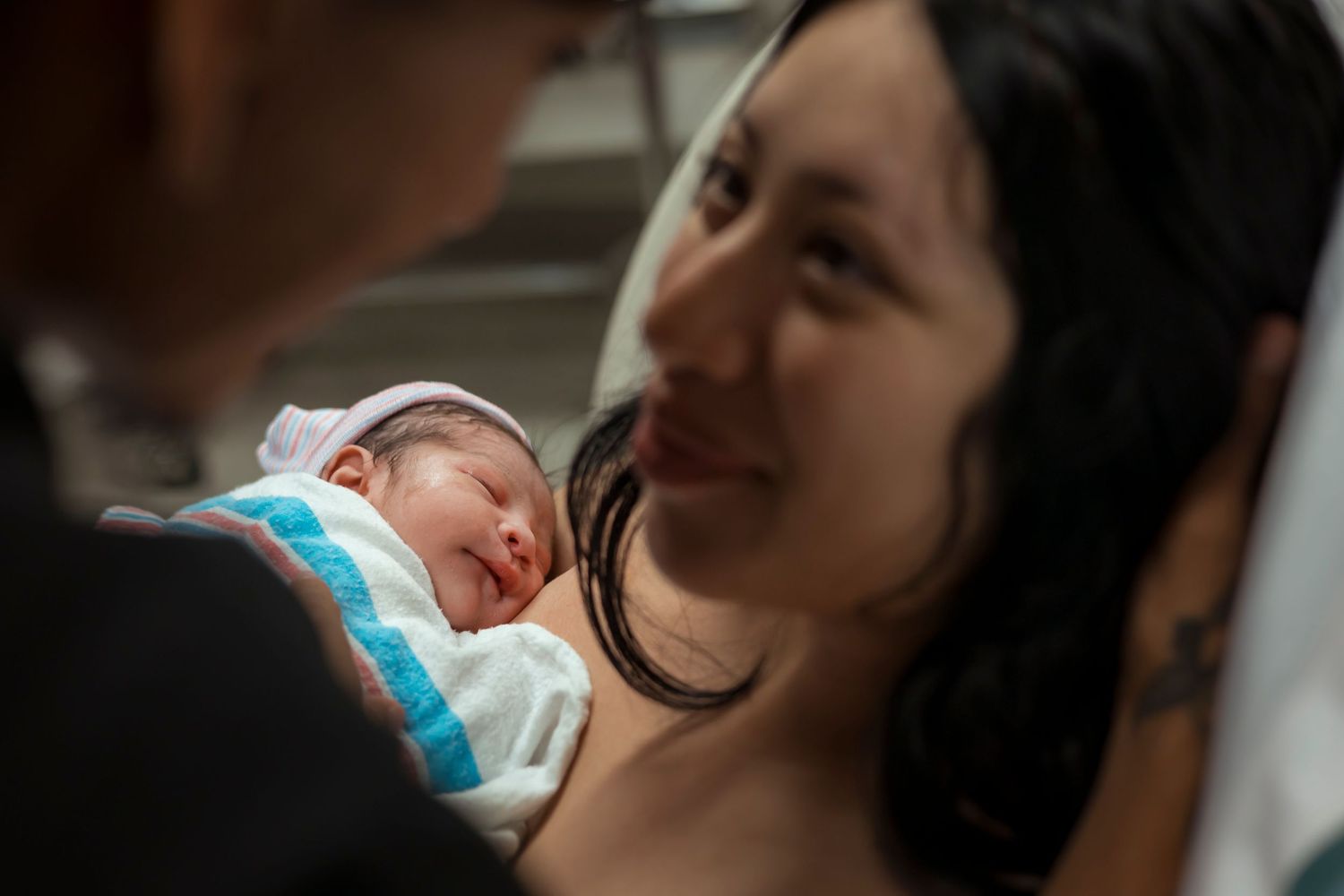 A tender moment between parents and their newborn baby in the hospital.
