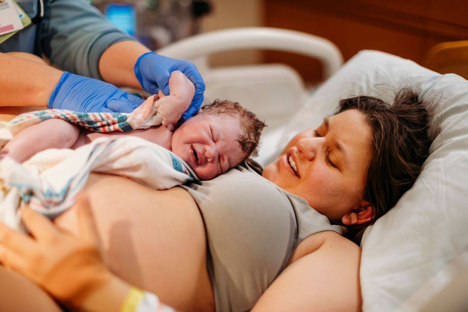 Medical professionals providing care during active labor in a hospital setting.