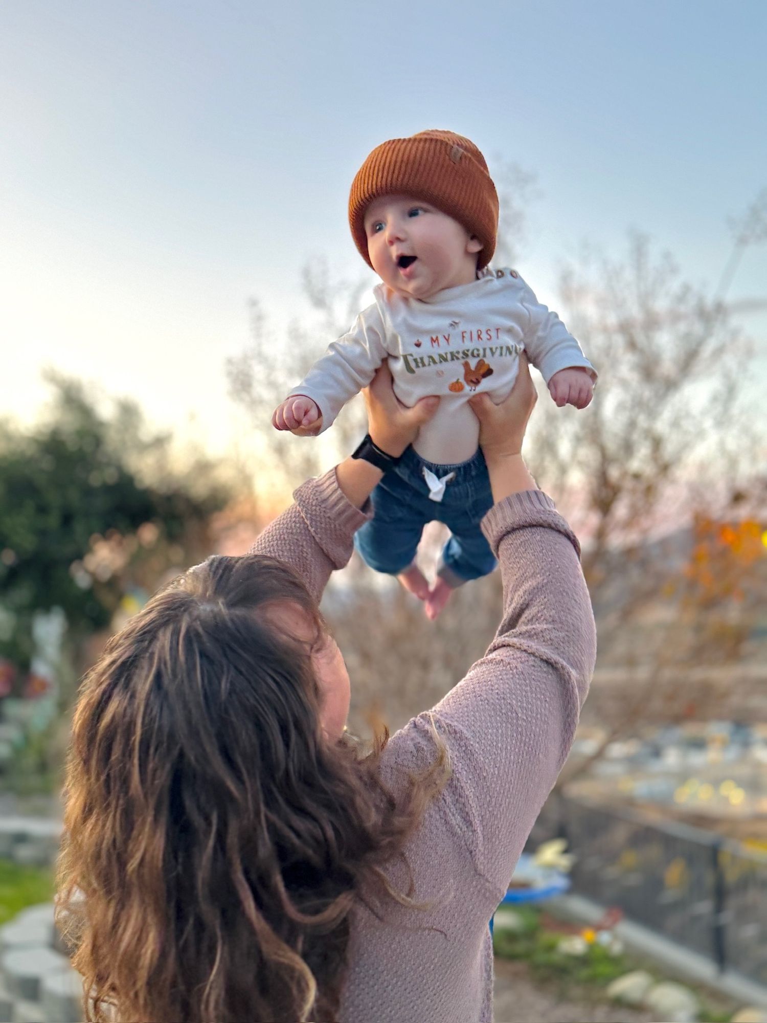 Hilary lifts a giggling Lucca during a Thanksgiving photoshoot break in Yucaipa