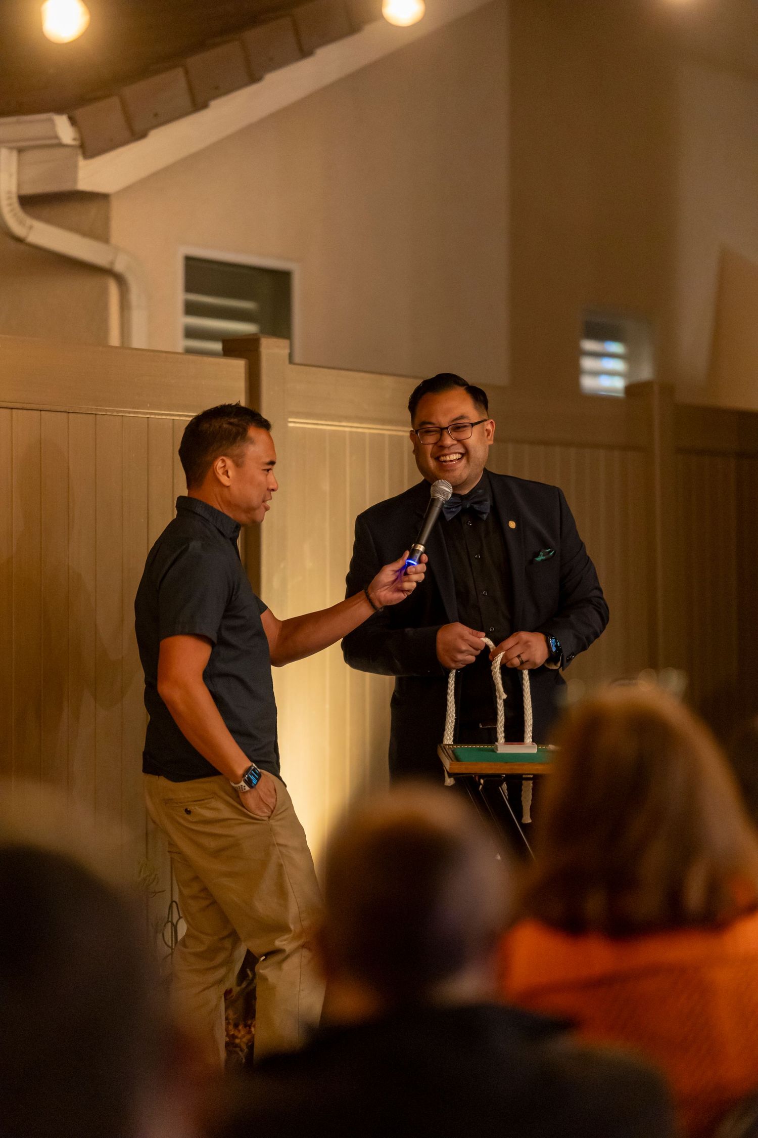 Two people engaged in an animated conversation during an indoor event in Anaheim.