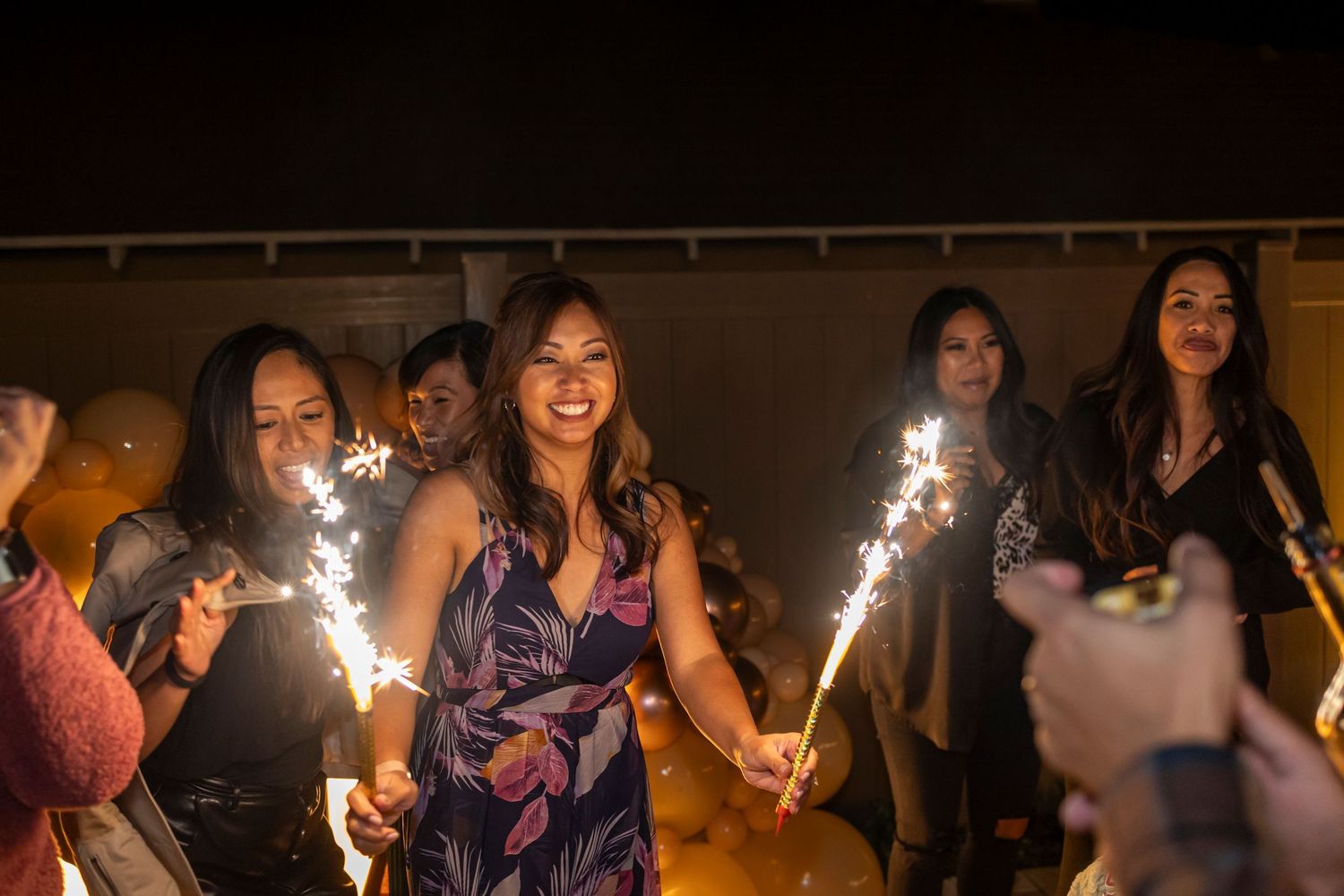 A celebration with sparklers creating a festive atmosphere in a dimly lit room in Anaheim.