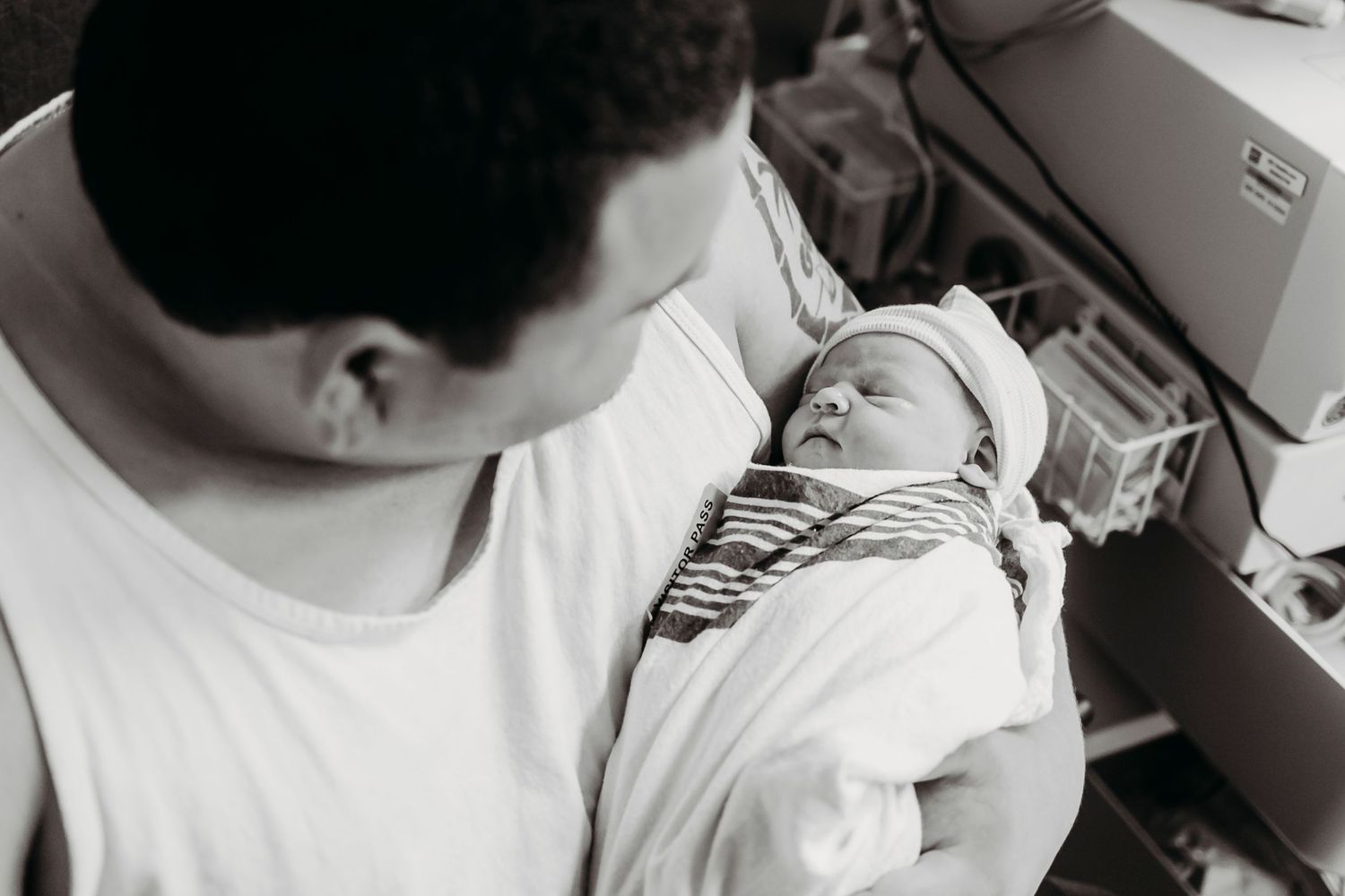 Black and white hospital images showing nurturing moments with a newborn.
