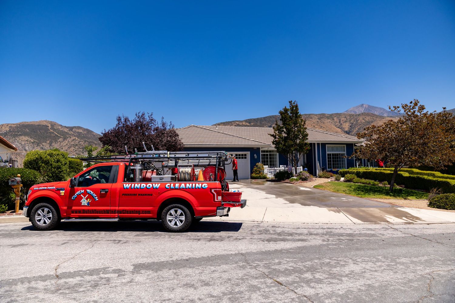 A red pickup truck shown from multiple angles parked in various outdoor locations with mountains in the background.