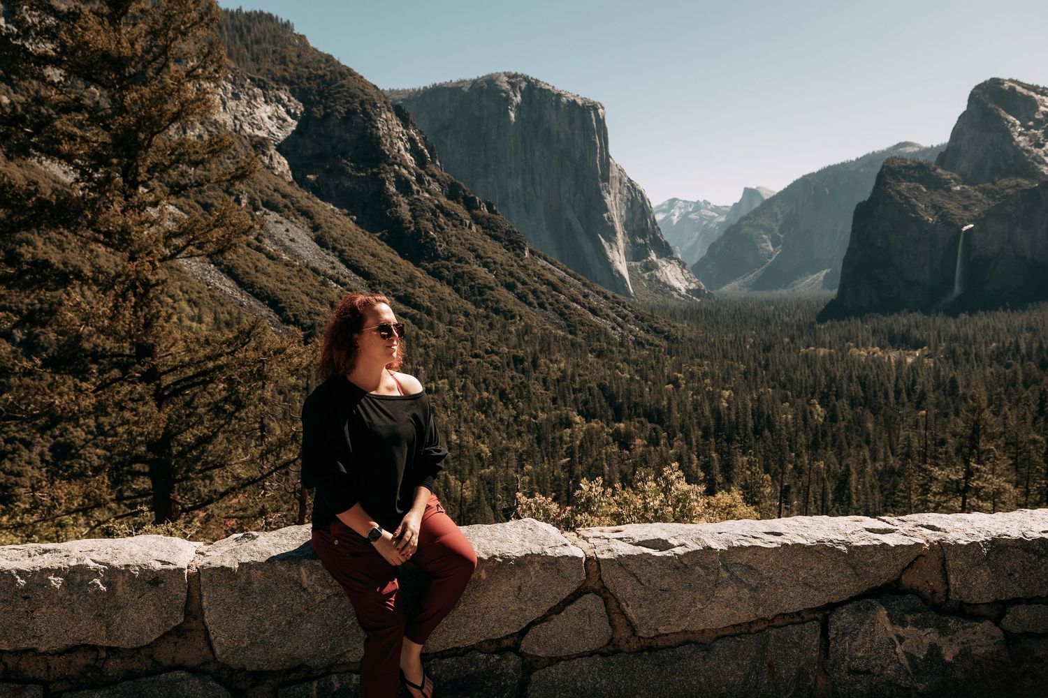 Hilary overlooking Yosemite Valley with El Capitan and Half Dome mountains in background.