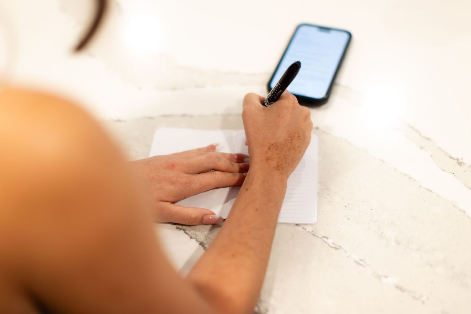 Close-up shot of hands using mobile devices during wedding preparations.