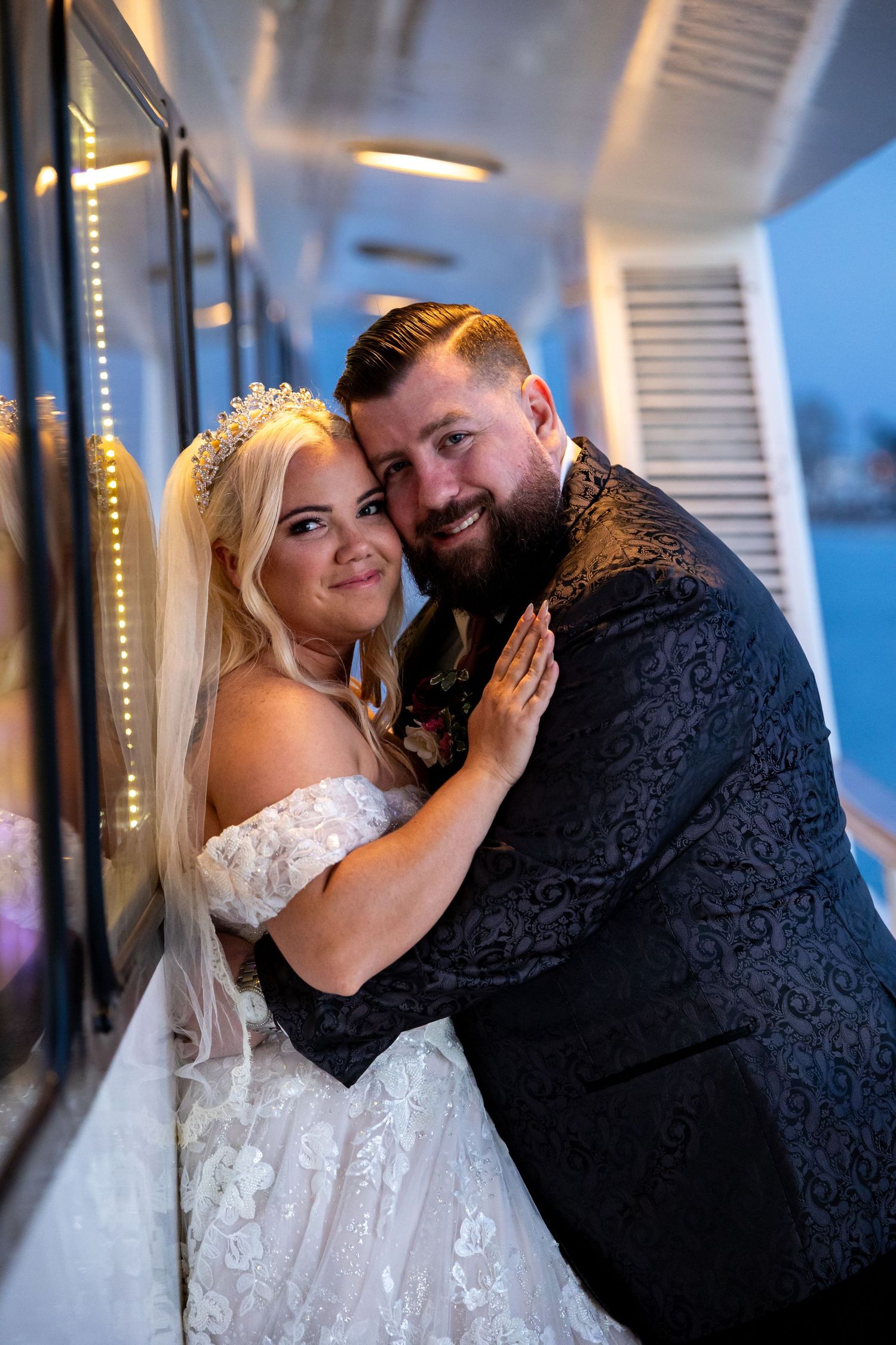 A romantic evening wedding portrait with soft lighting and elegant formal attire.