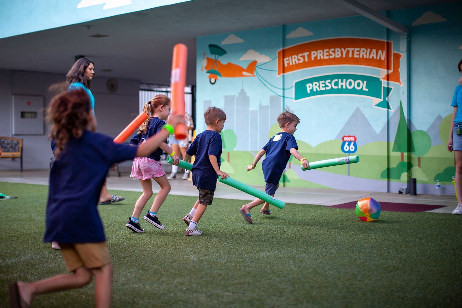 Youth soccer players practicing drills on an indoor field with vibrant blue and white jerseys in action.