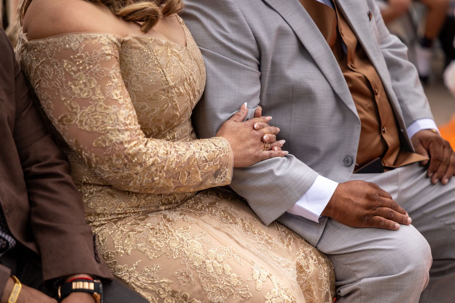 Formal event attendees in elegant brown and gray attire seated together in San Jacinto.
