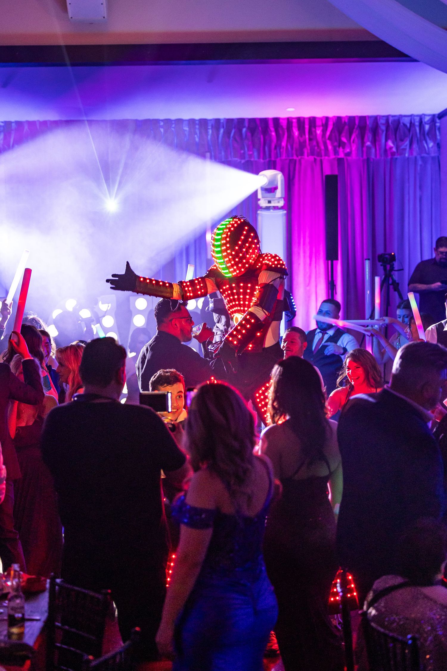 Crowded dance party with colorful robot in Moreno Valley